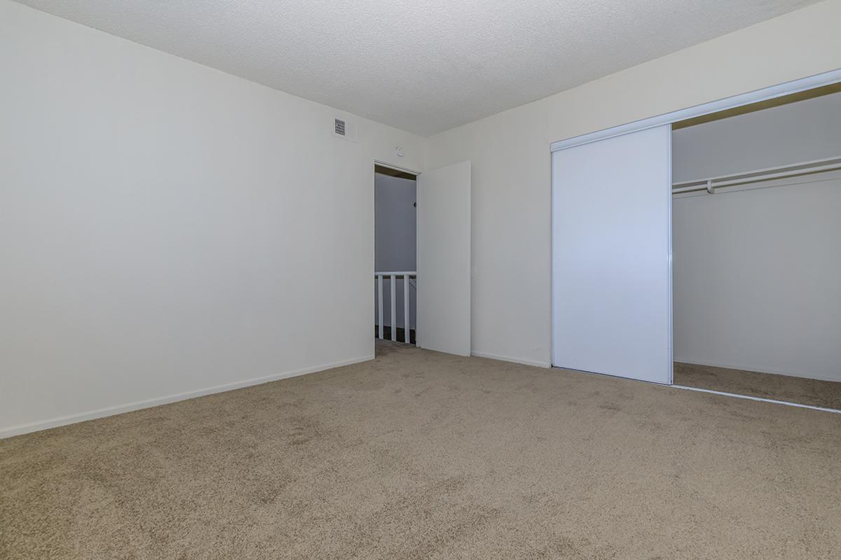 Bedroom with open closet doors