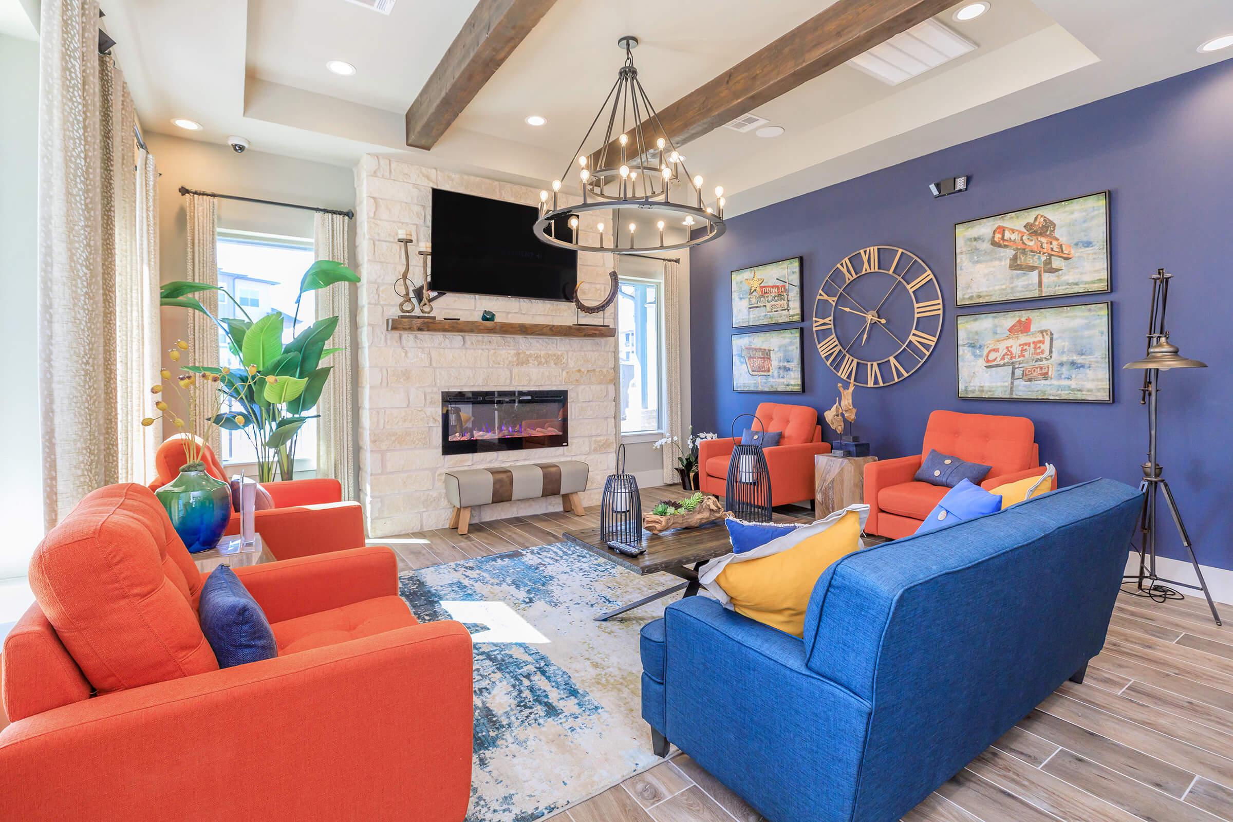 a living room with blue furniture and a fire place