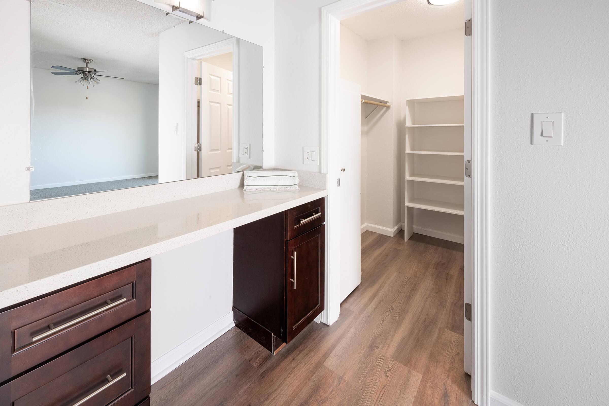 a kitchen with a sink and a mirror