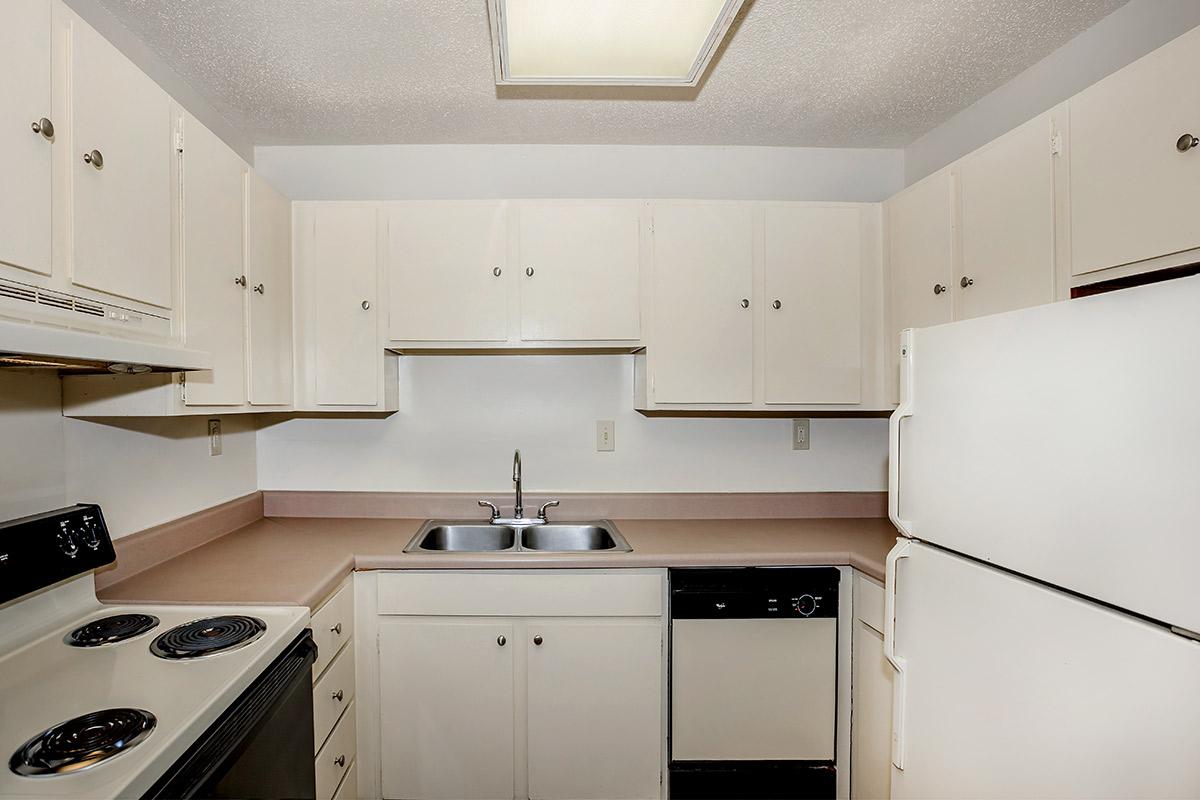 a white stove top oven sitting inside of a kitchen