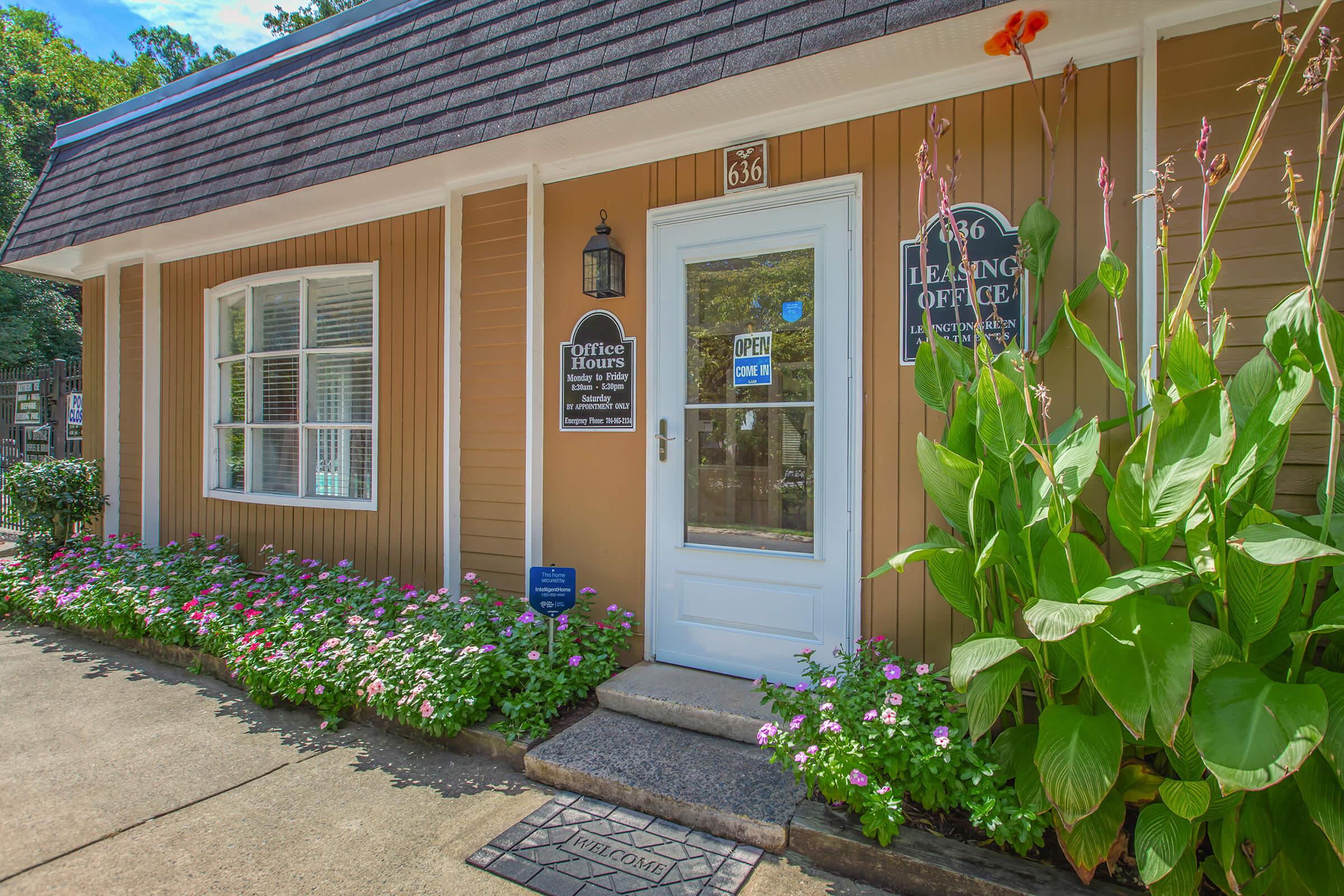 a close up of a flower garden in front of a building