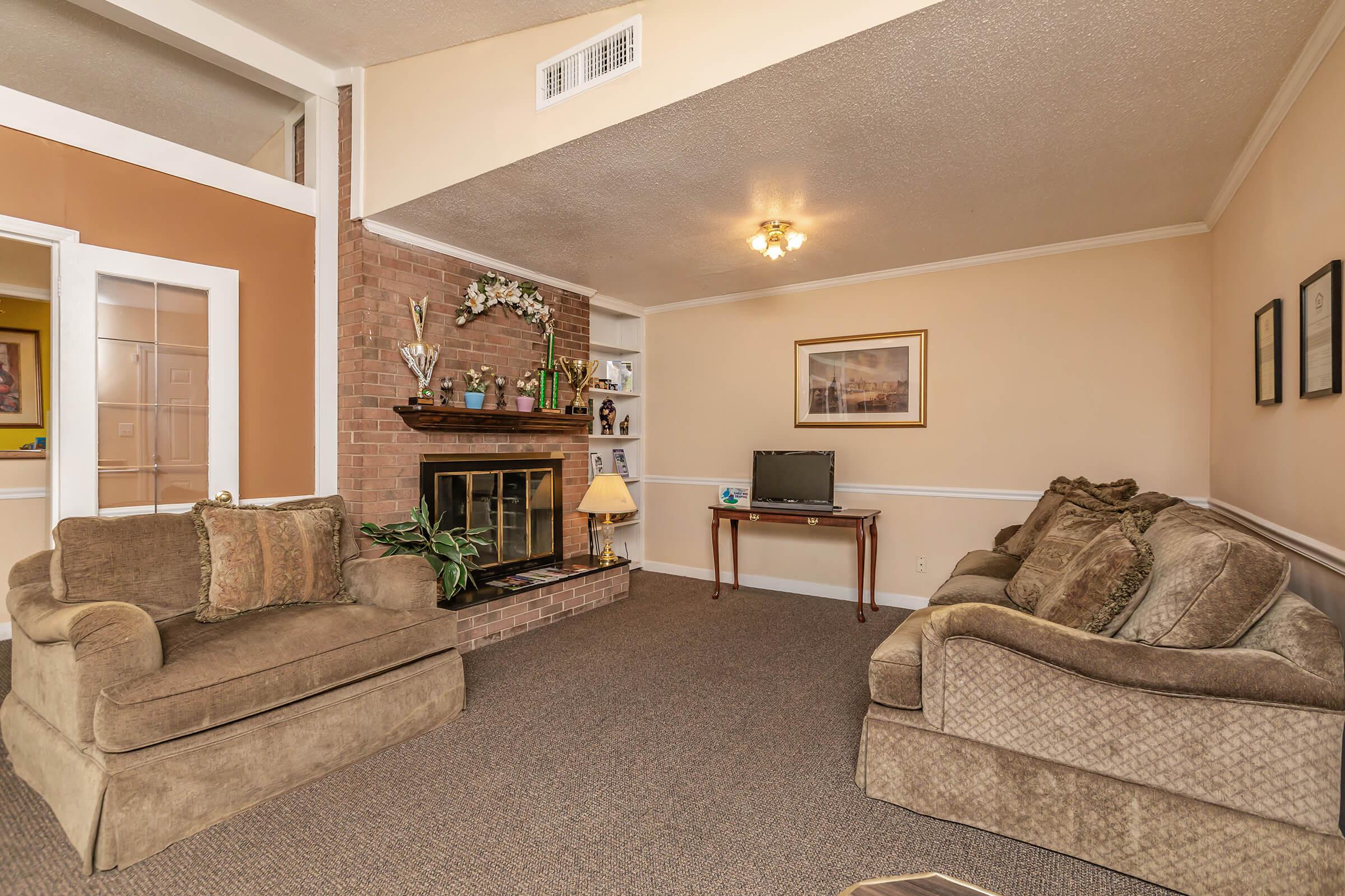 a living room filled with furniture and a flat screen tv