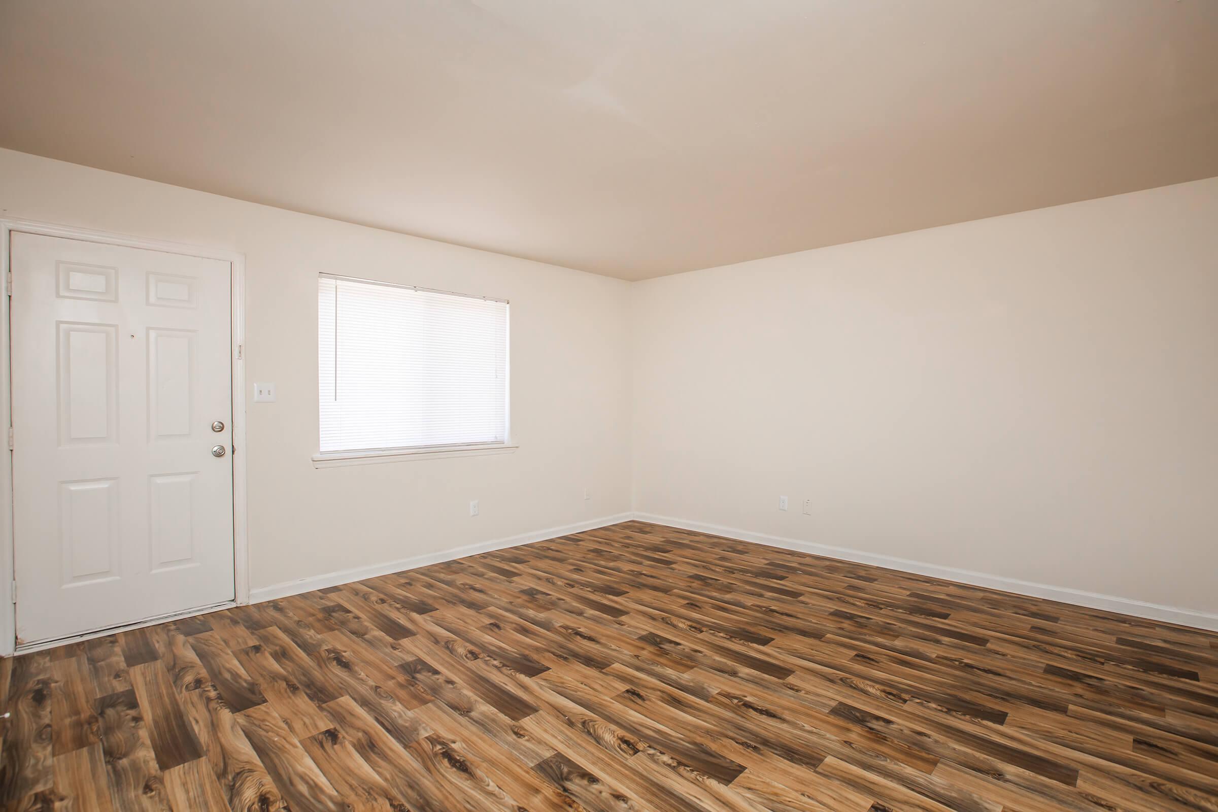 a bedroom with a wooden floor