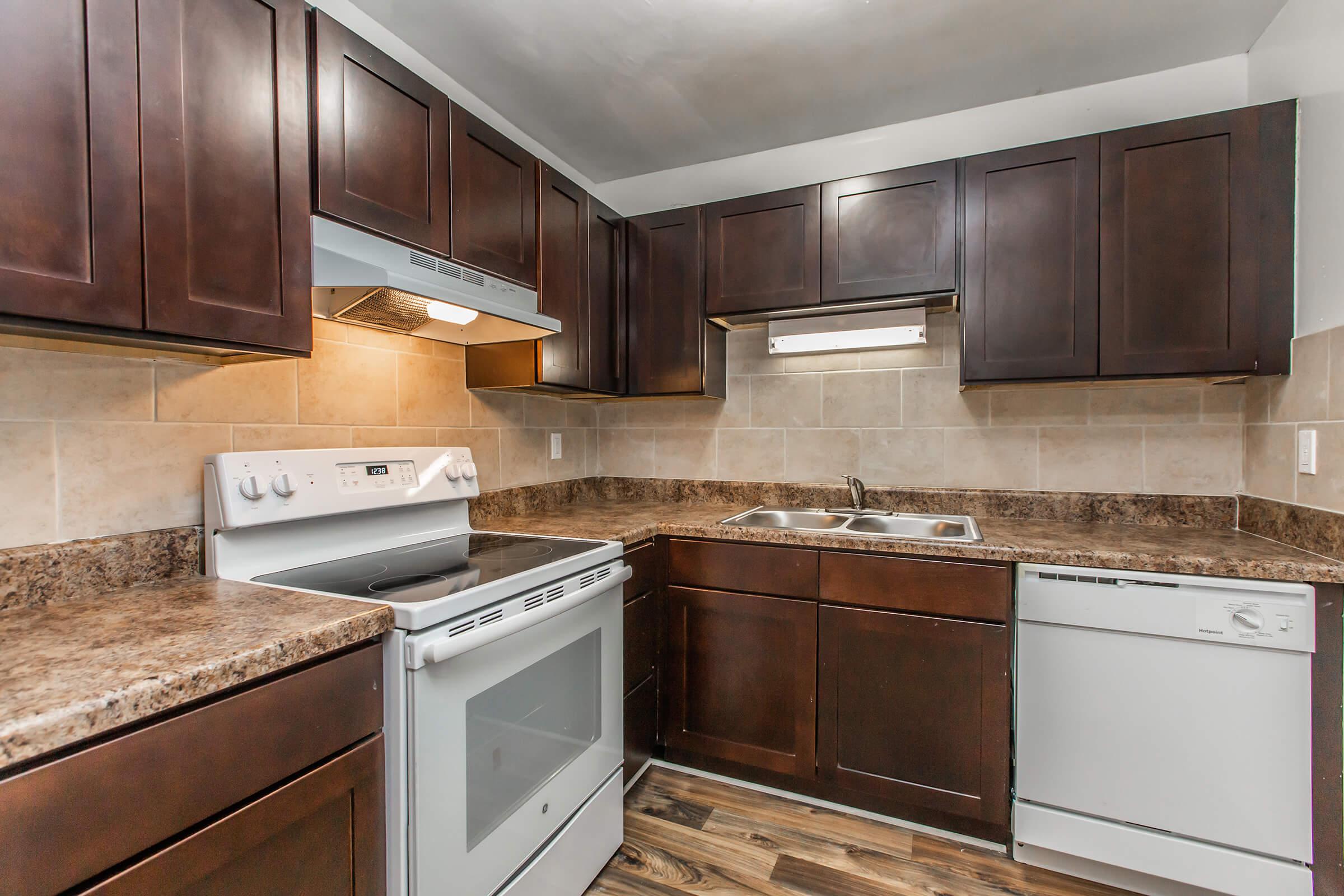 a kitchen with stainless steel appliances and wooden cabinets