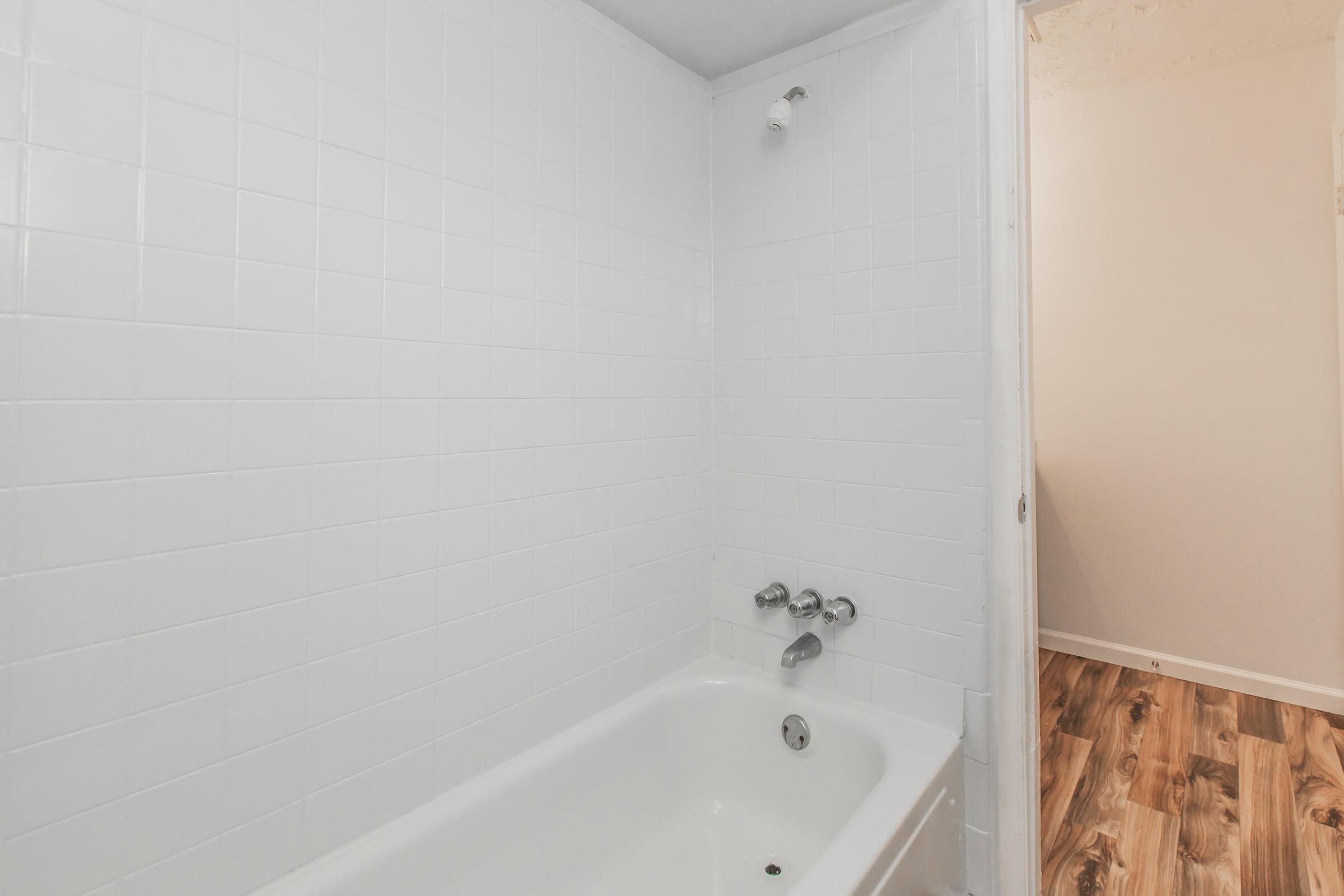 a white tub sitting next to a sink