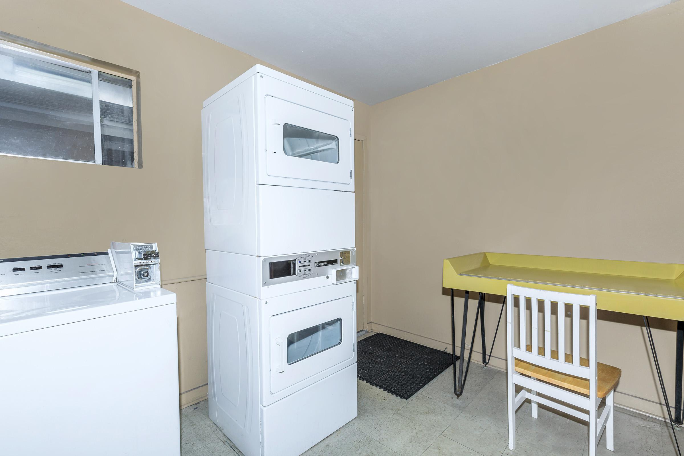 a kitchen with a stove top oven sitting inside of a room