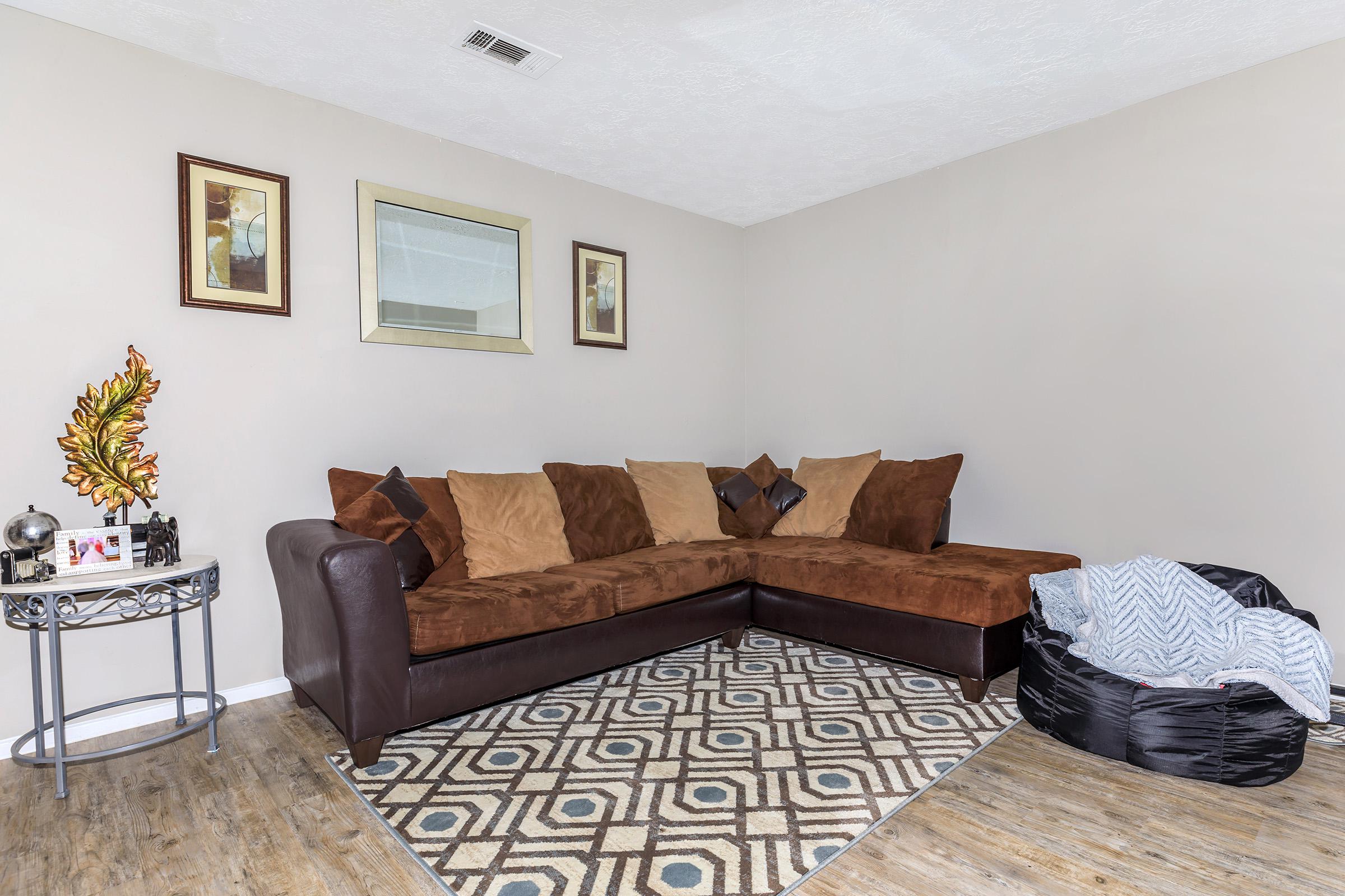 a living room filled with furniture and a rug