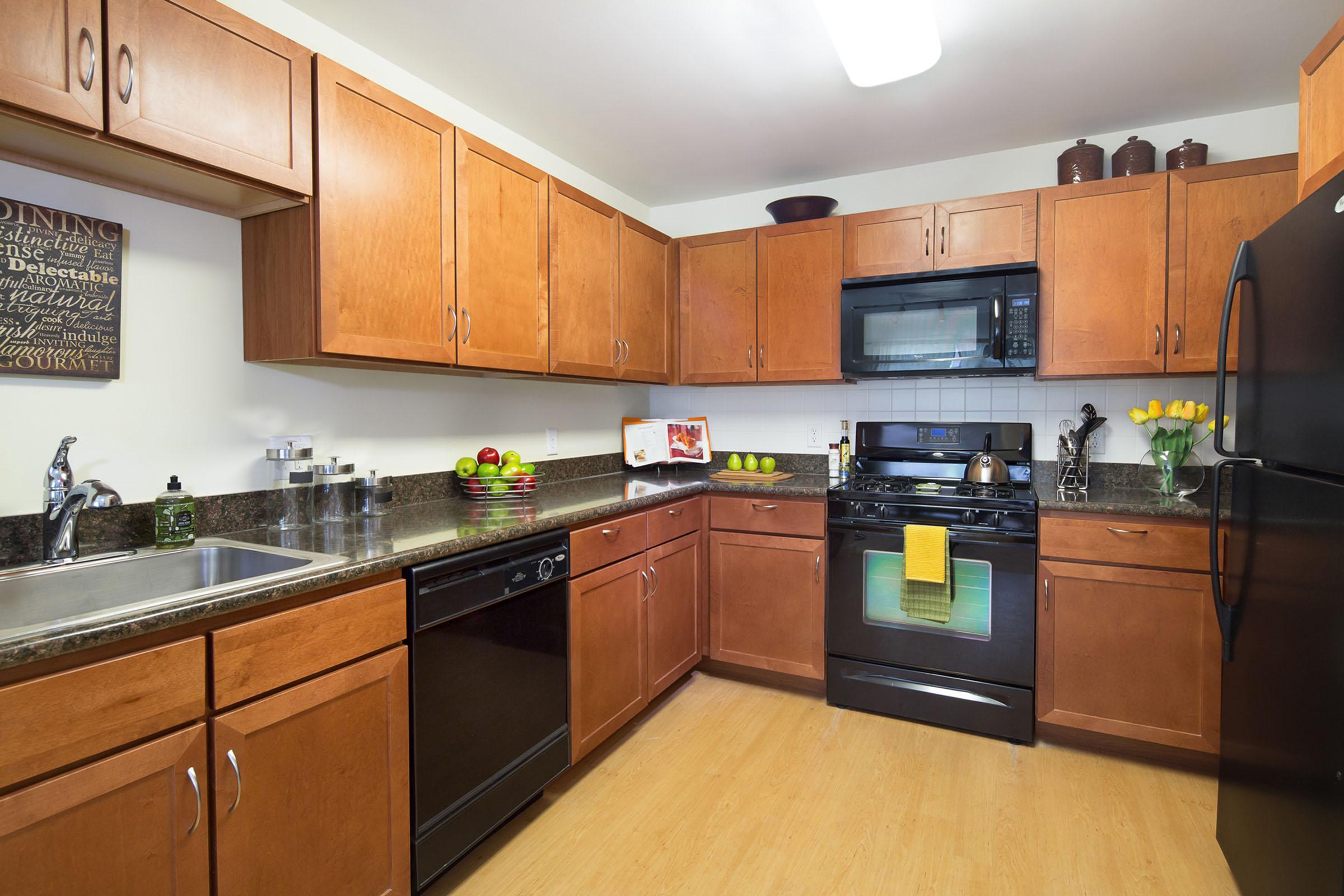 a kitchen with stainless steel appliances and wooden cabinets