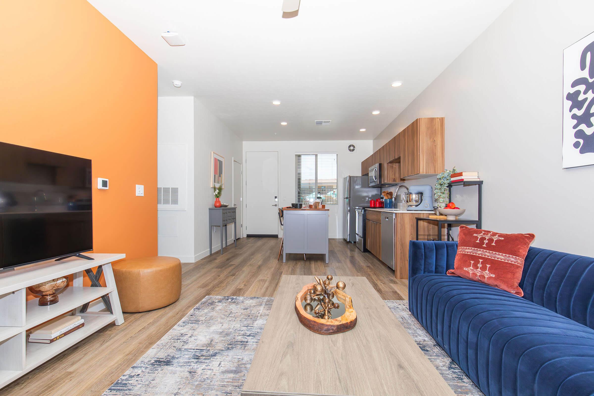 a living room filled with furniture and a flat screen tv