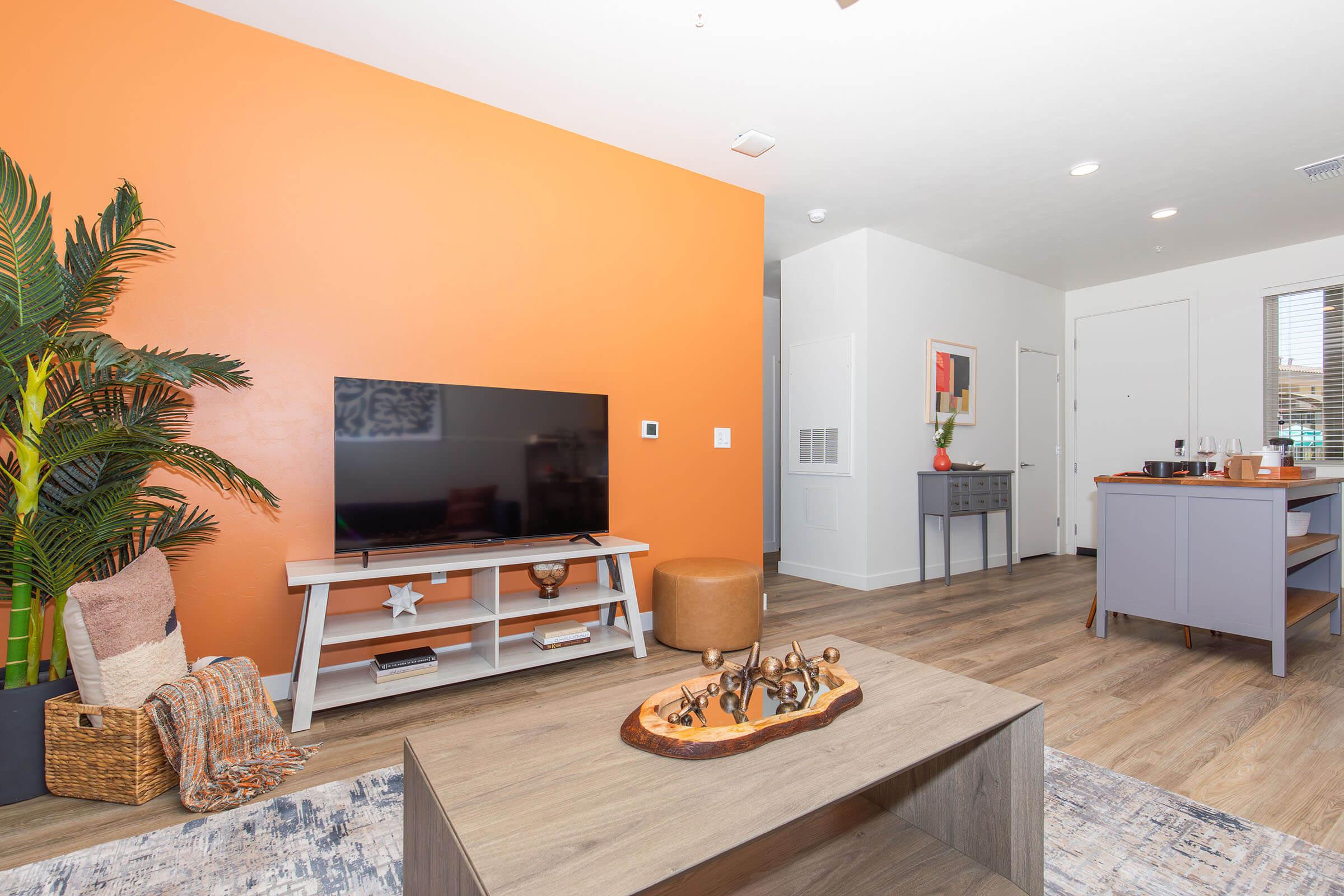 a living room filled with furniture and a flat screen tv