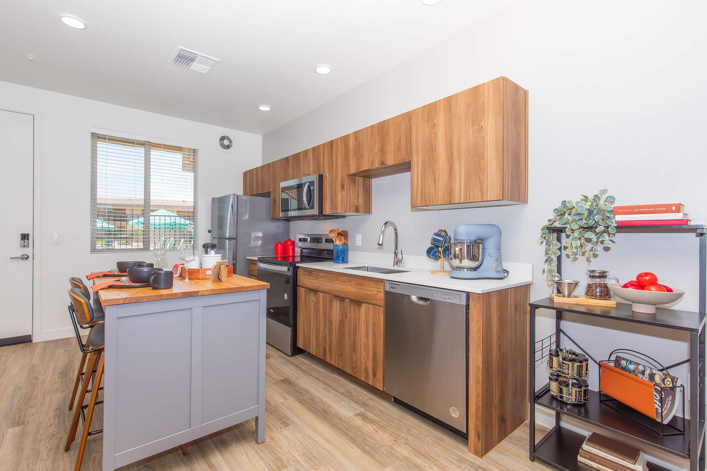 a modern kitchen with stainless steel appliances and wooden cabinets