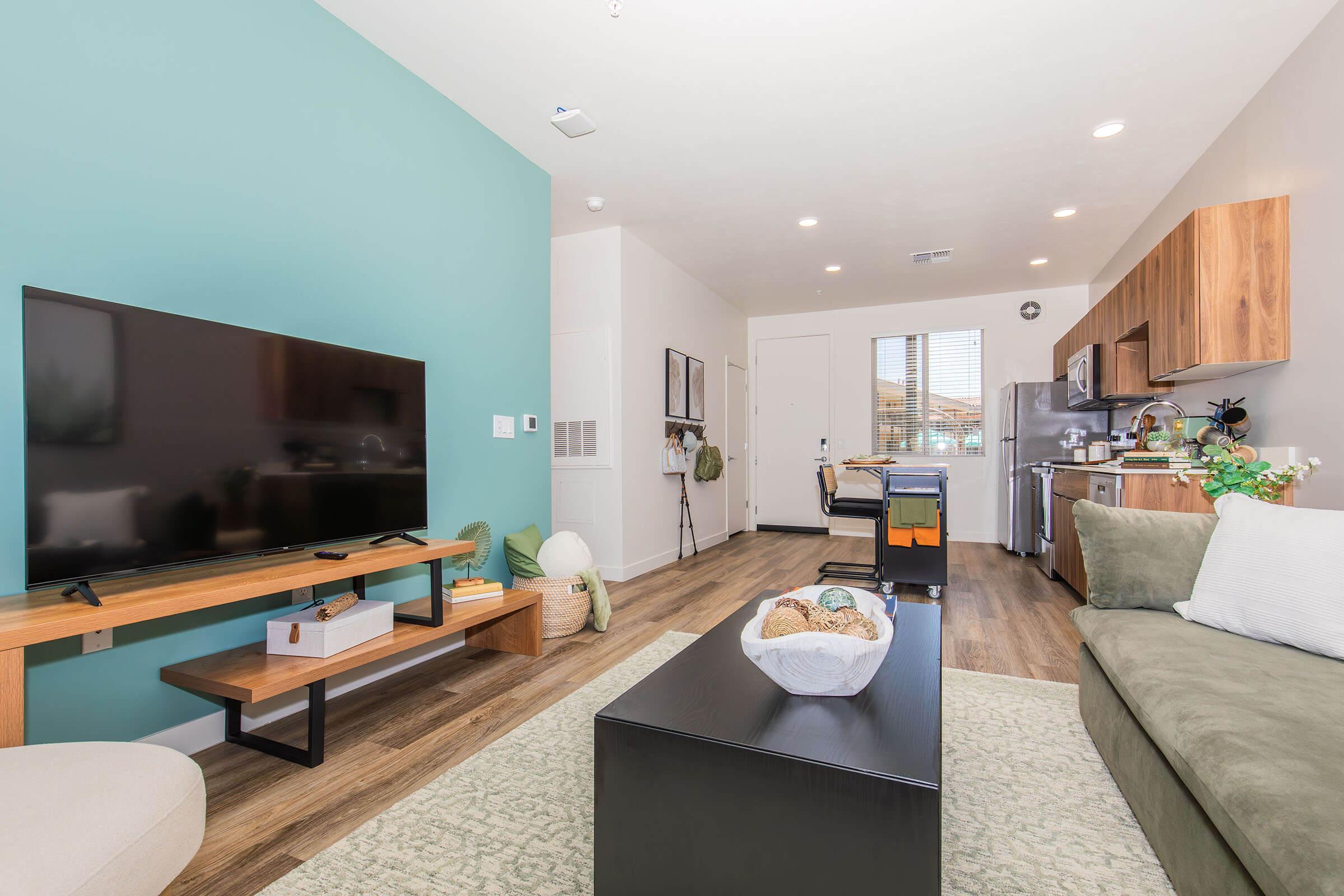 a living room filled with furniture and a flat screen tv