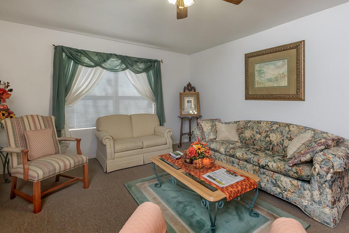 a living room filled with furniture and a tv