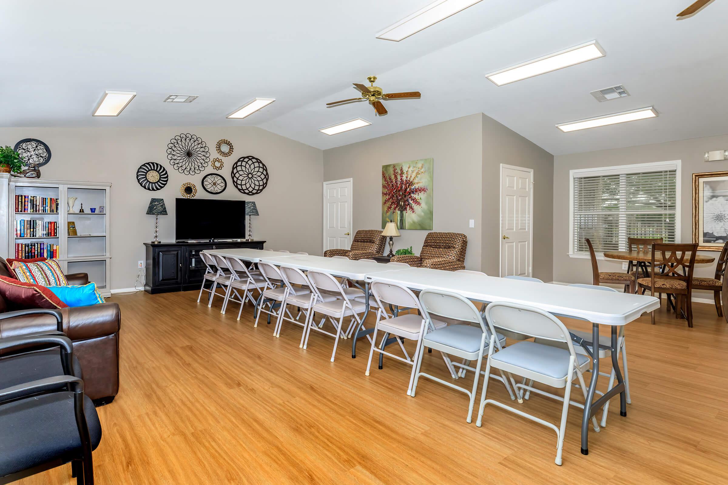 a living room filled with furniture and a wood floor