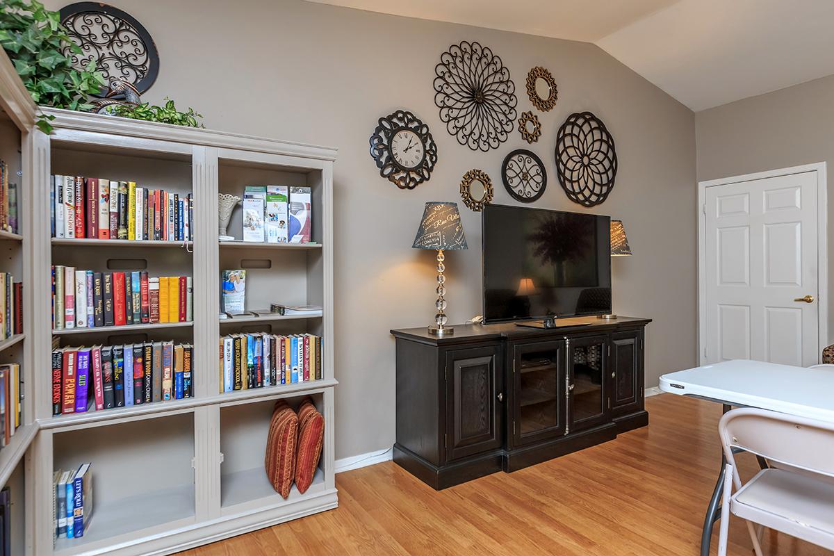 a living room filled with furniture and a book shelf