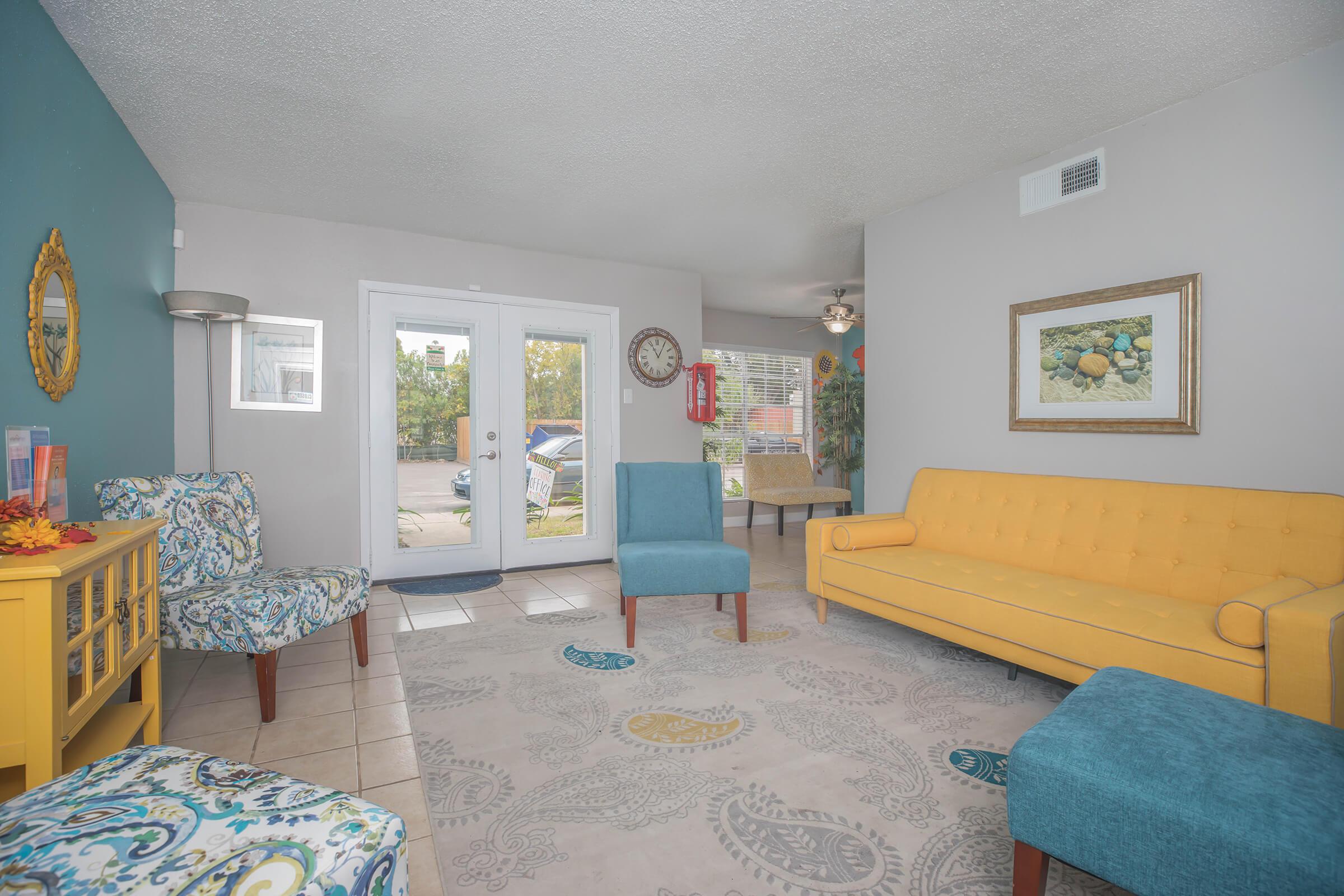 a living room filled with furniture and a blue sky