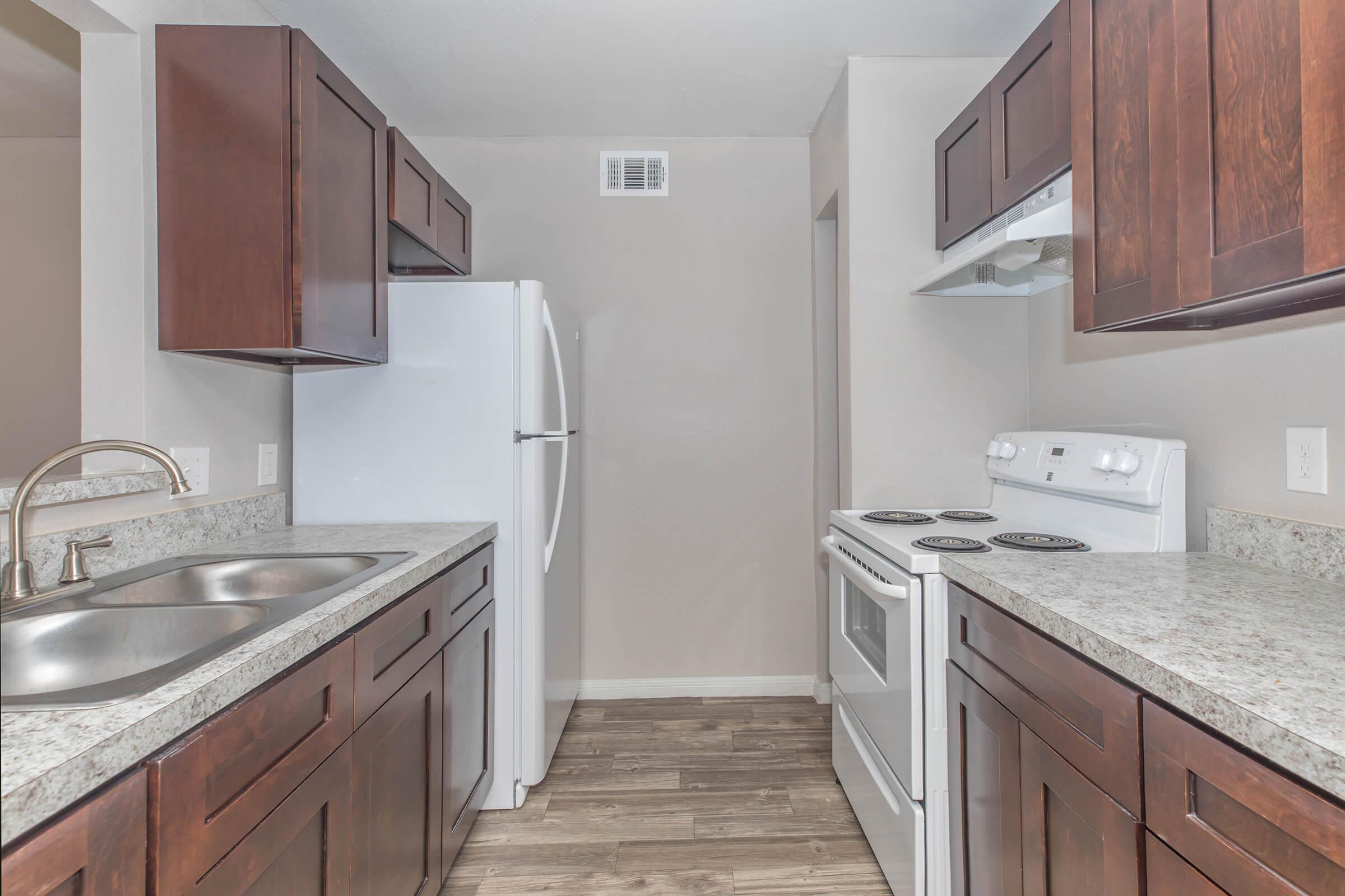a kitchen with stainless steel appliances and wooden cabinets