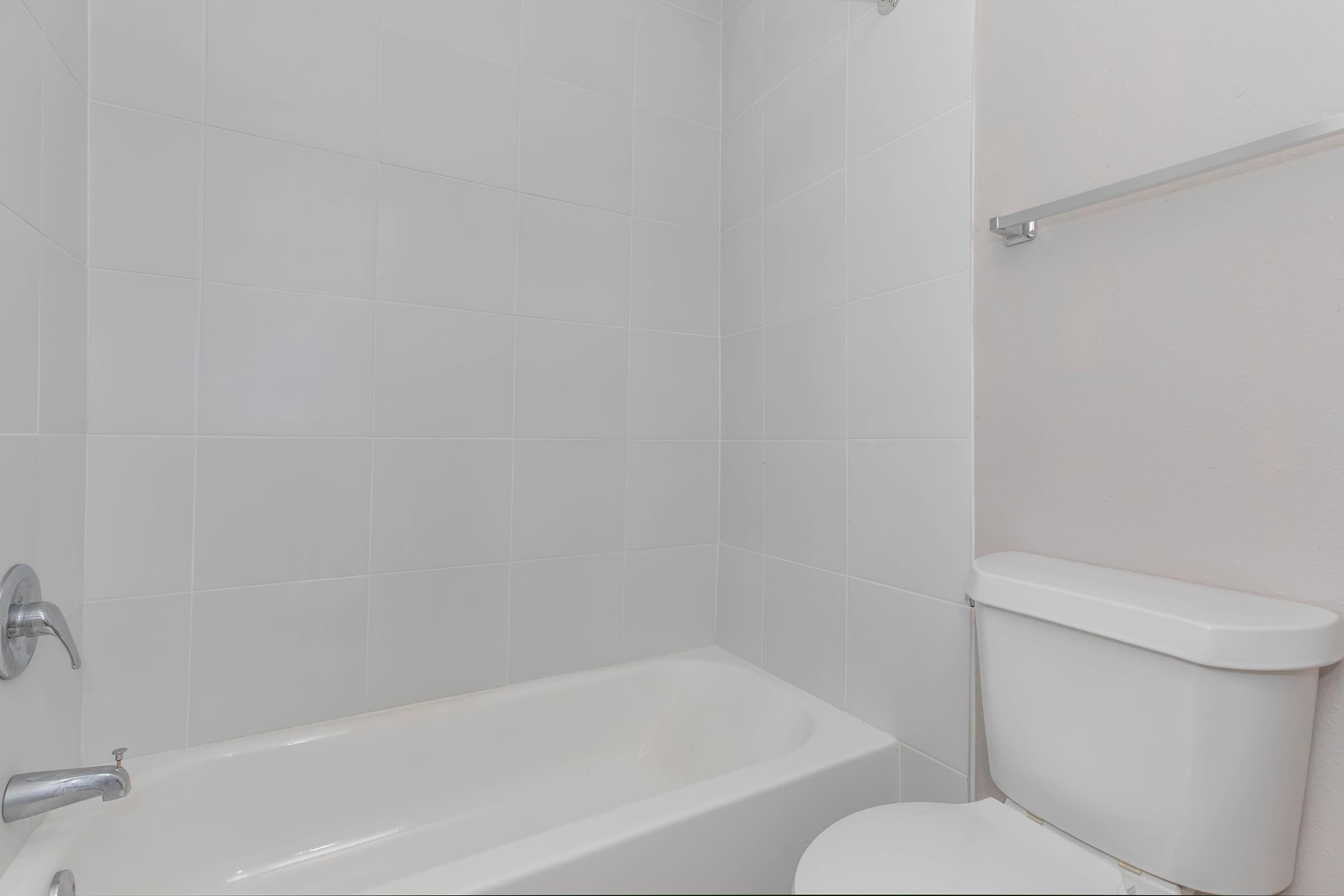 a white tub sitting next to a sink
