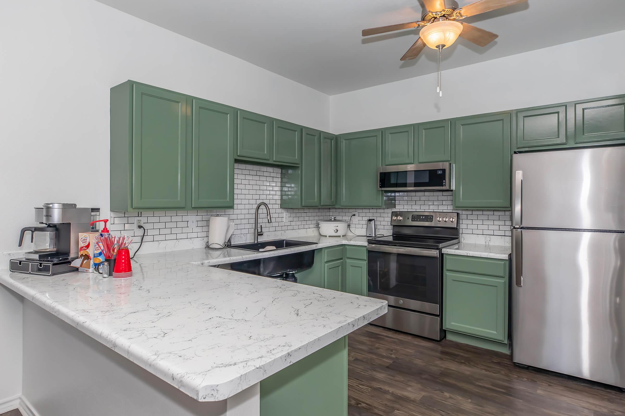 a kitchen with green walls