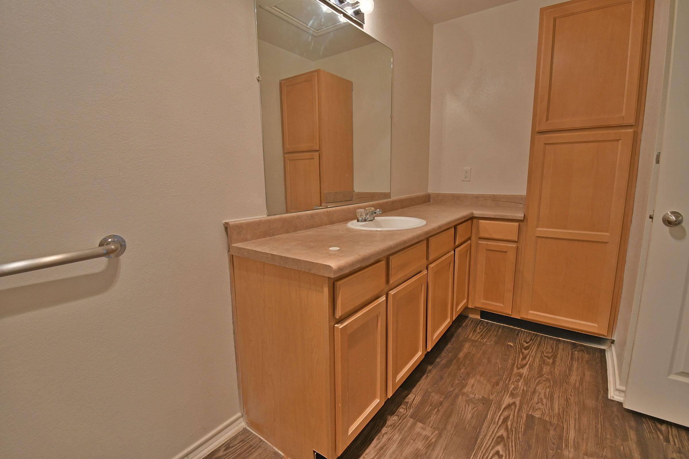 a kitchen with a sink and a mirror