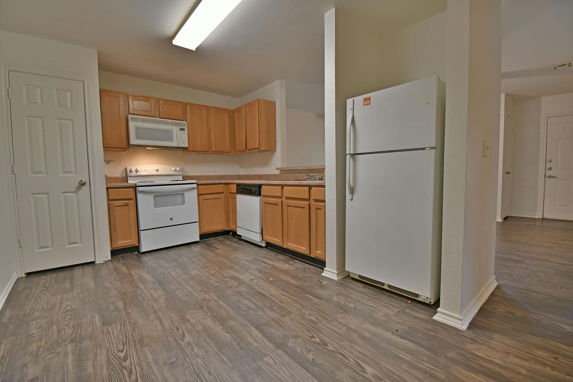 a kitchen with a stove and a refrigerator