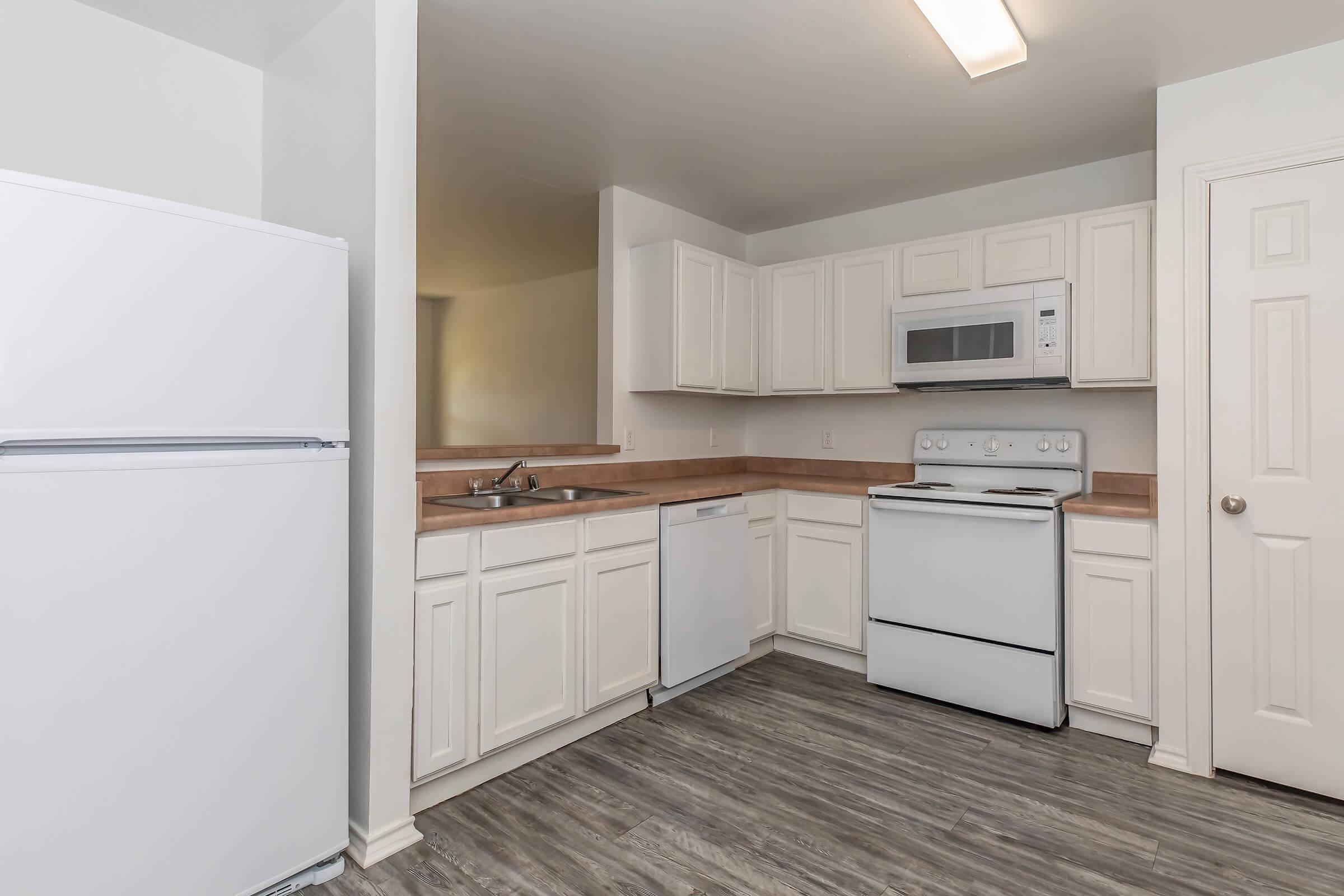 a kitchen with a stove and a refrigerator