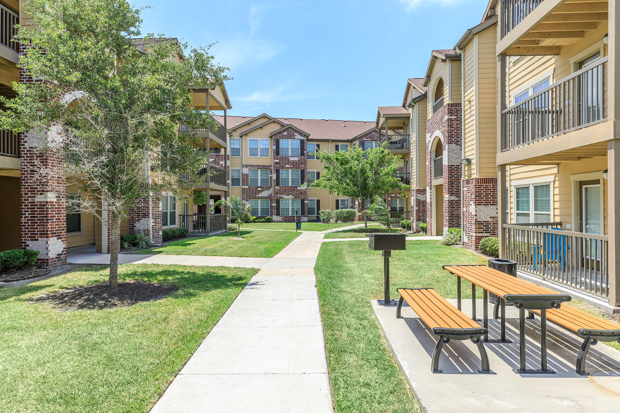 an empty park bench sitting in front of a building