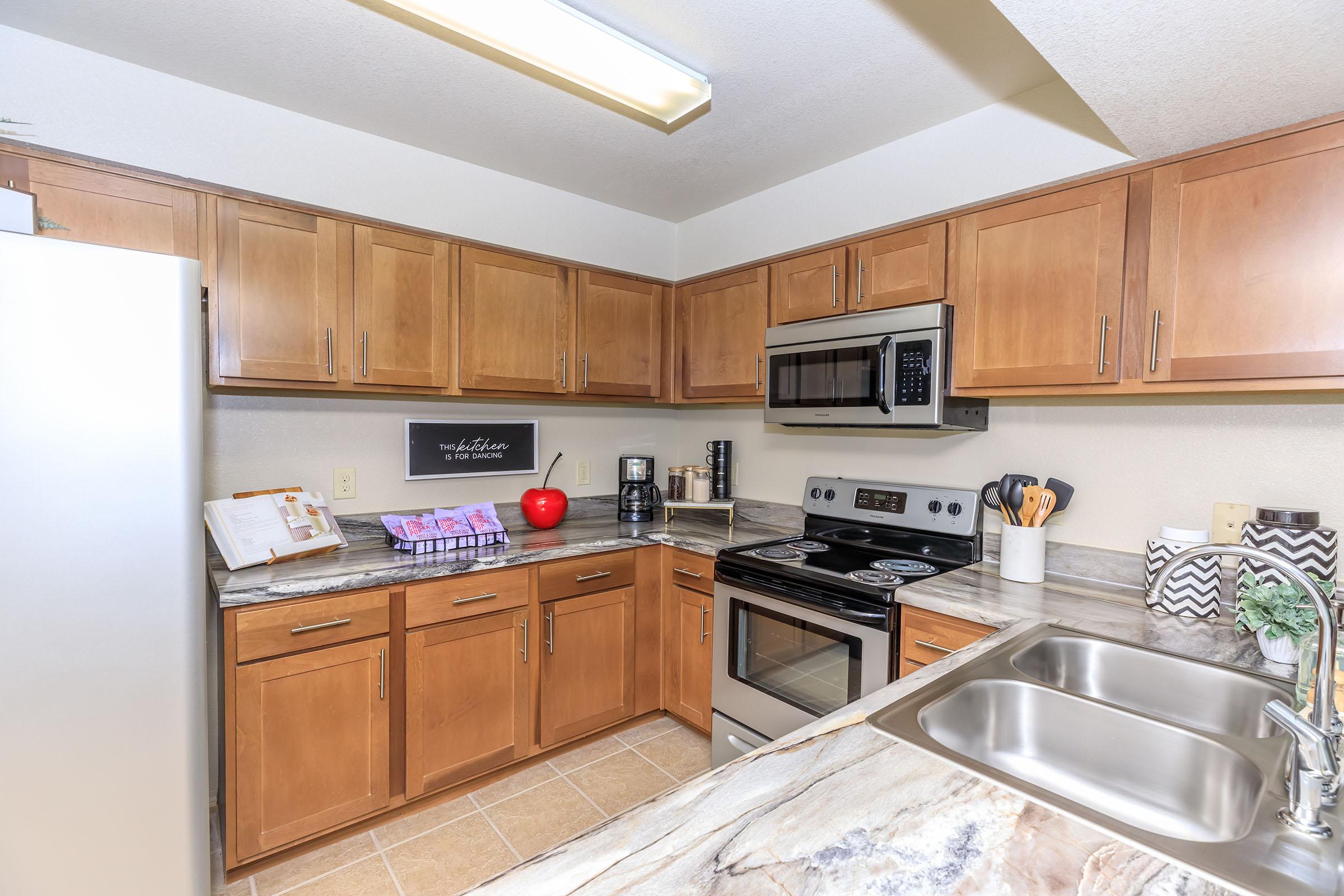 a kitchen with stainless steel appliances and wooden cabinets