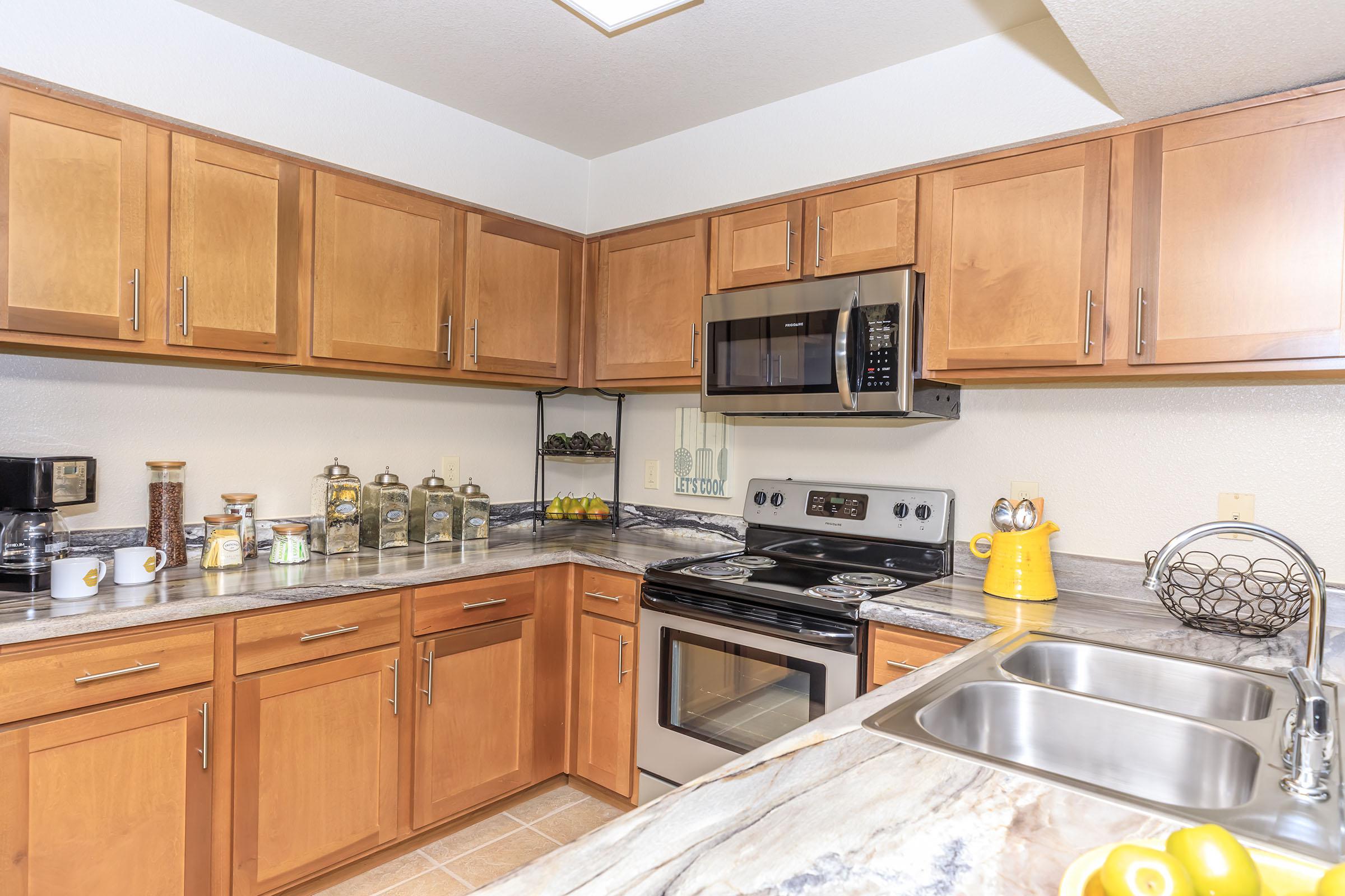 a kitchen with stainless steel appliances and wooden cabinets