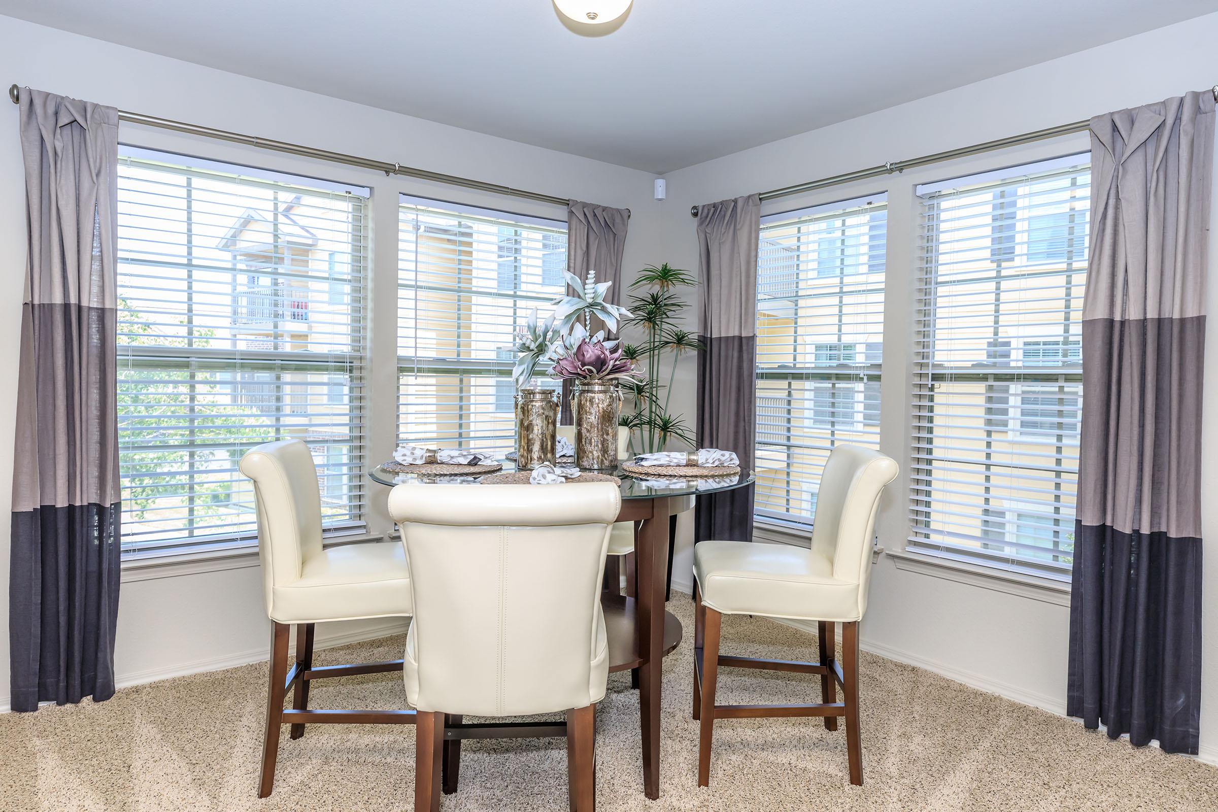 a living room filled with furniture and a large window