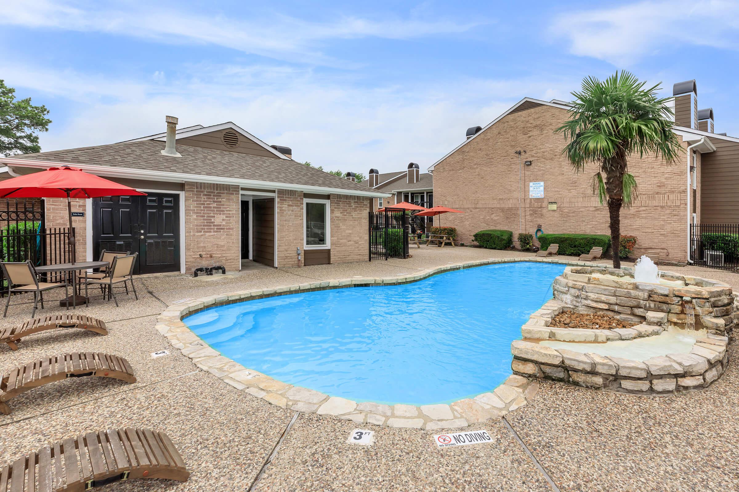 a large pool of water in front of a house