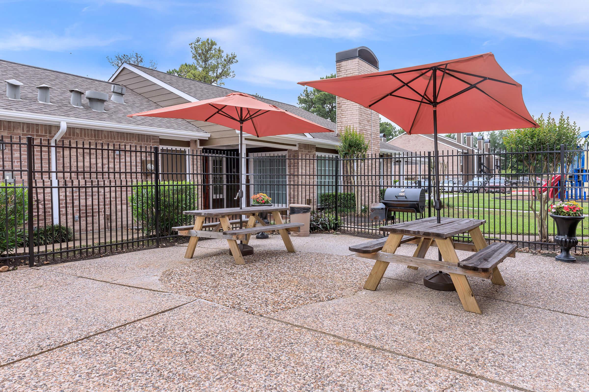 a house with a fence in front of a building