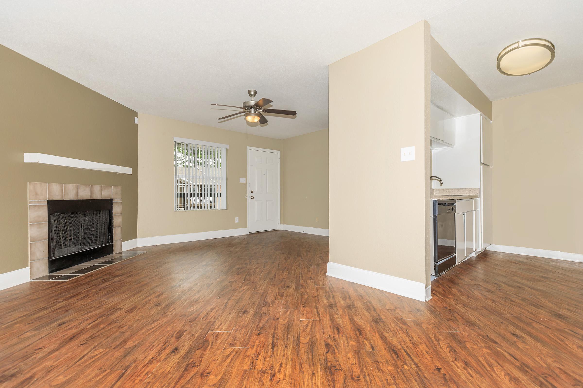 a large empty room with a wood floor