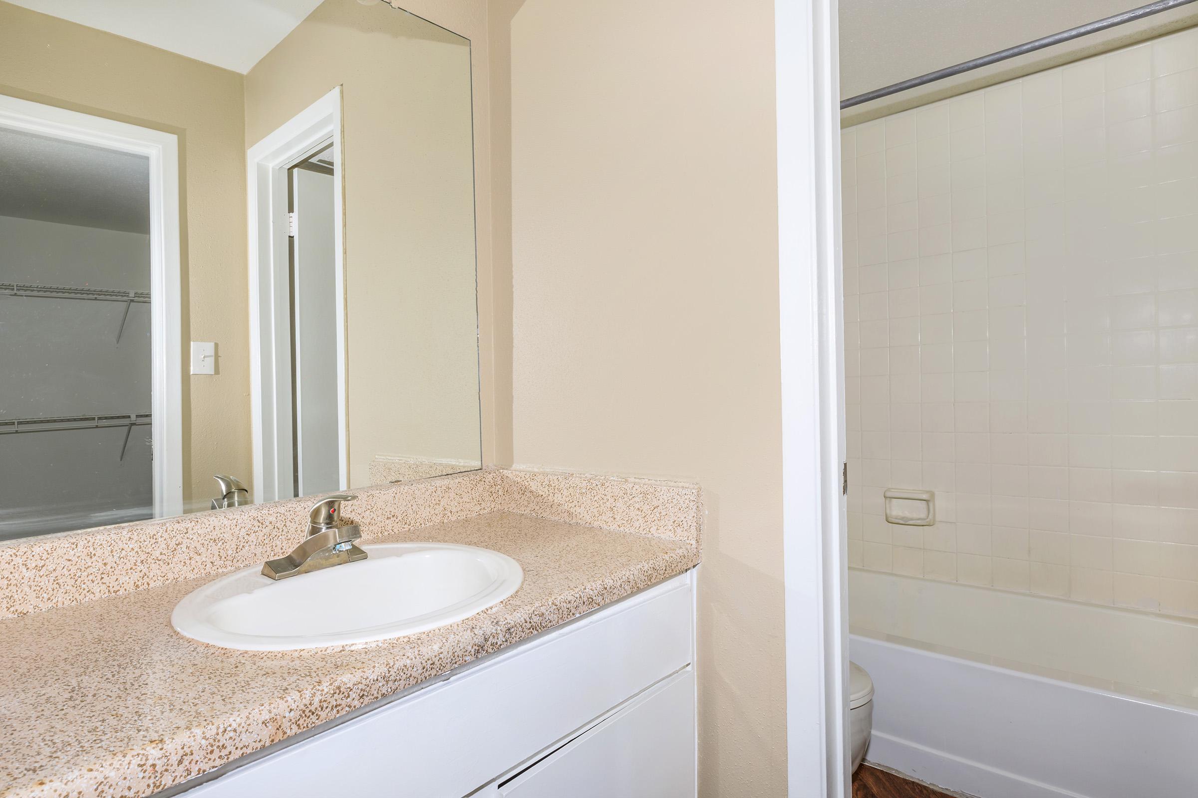 a room with a sink and a mirror