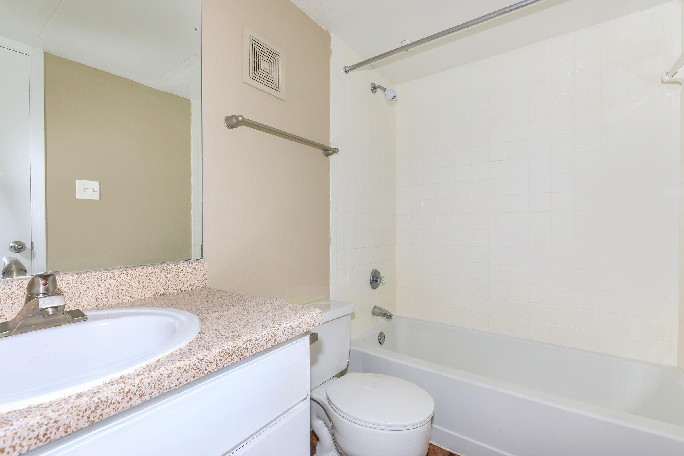 a white tub sitting next to a sink