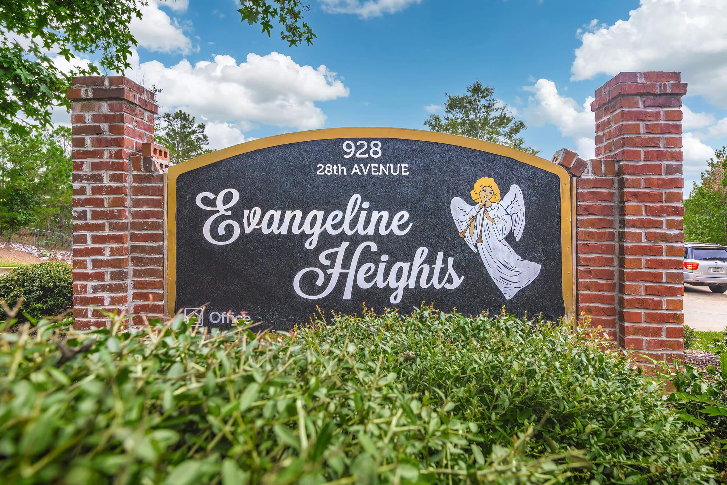 Sign for Evangeline Heights located at 928 28th Avenue, featuring an angel illustration and surrounded by greenery. The sign has a decorative brick border and is set against a blue sky with clouds.