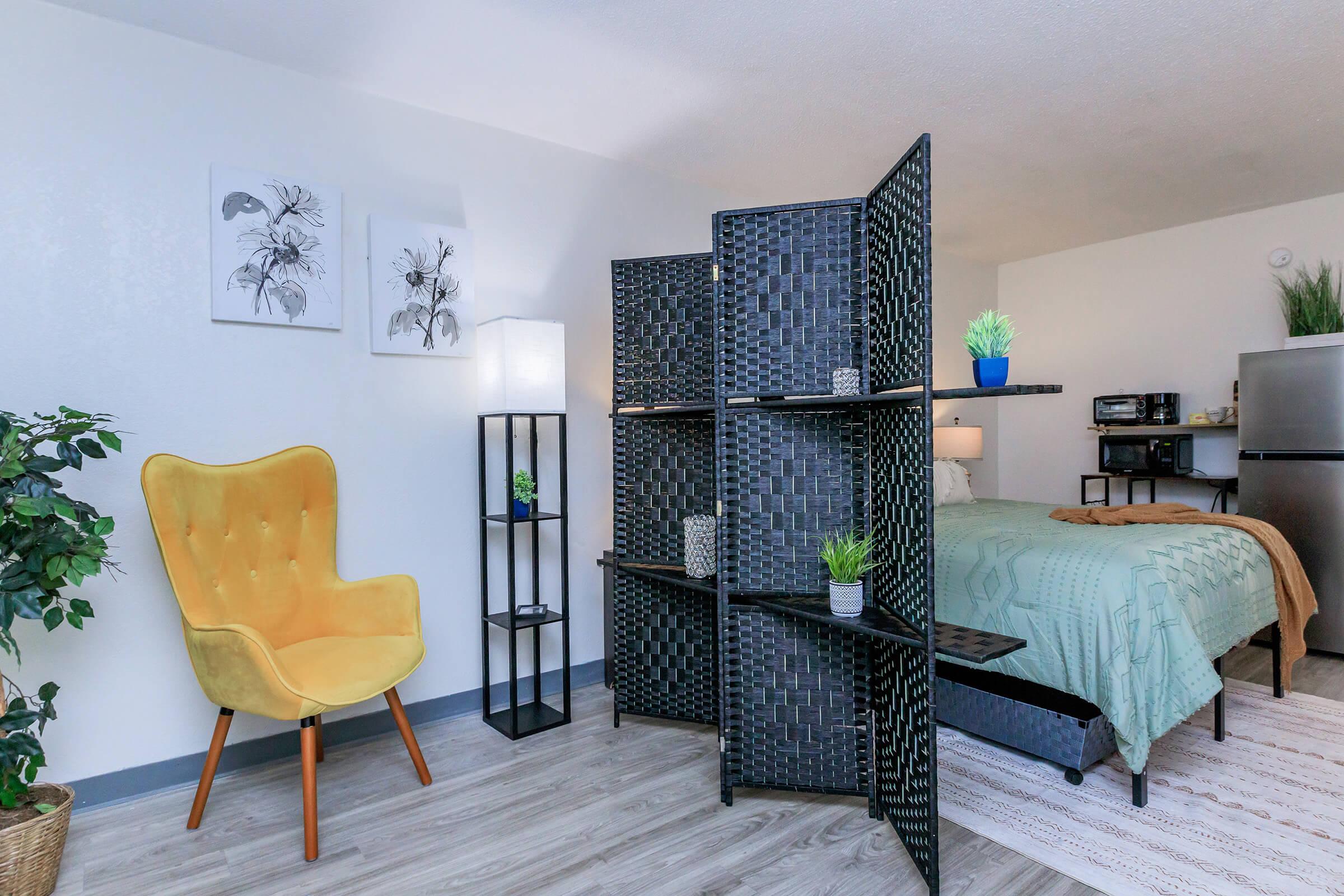 a living room filled with furniture and a bed