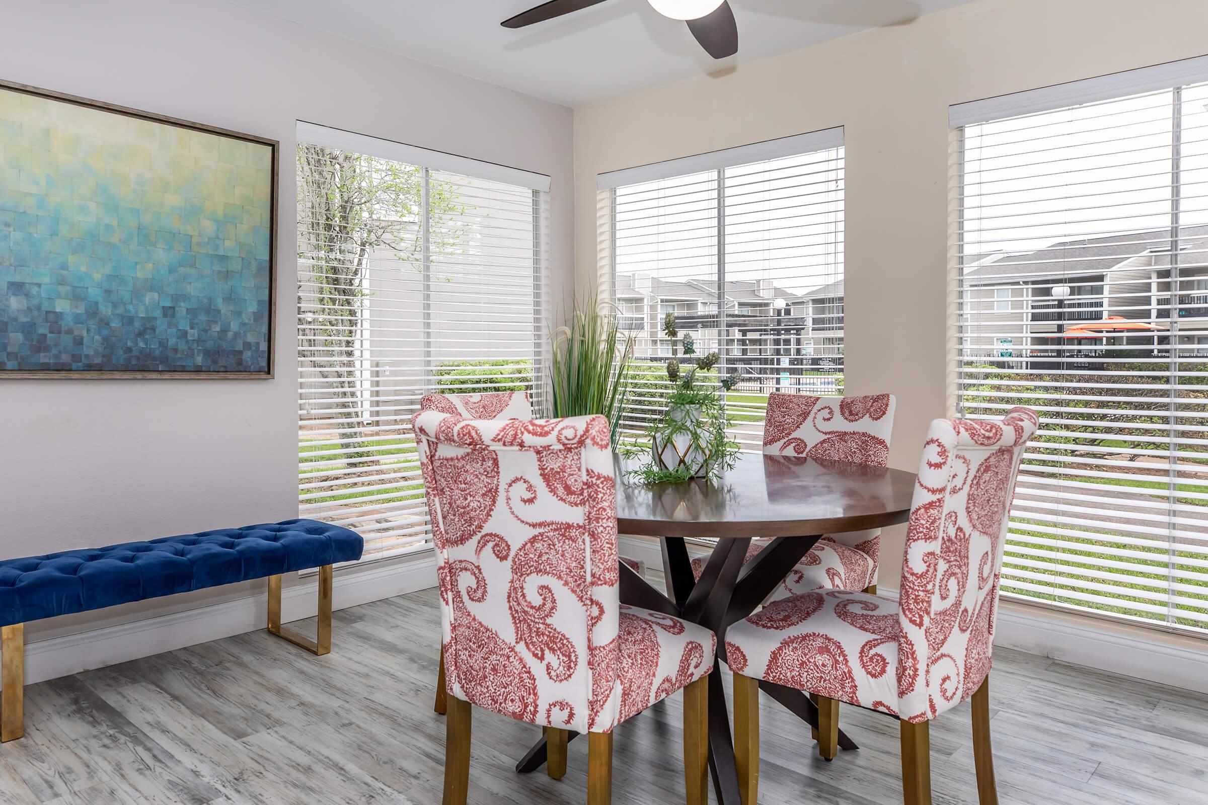 a living room filled with furniture and a large window