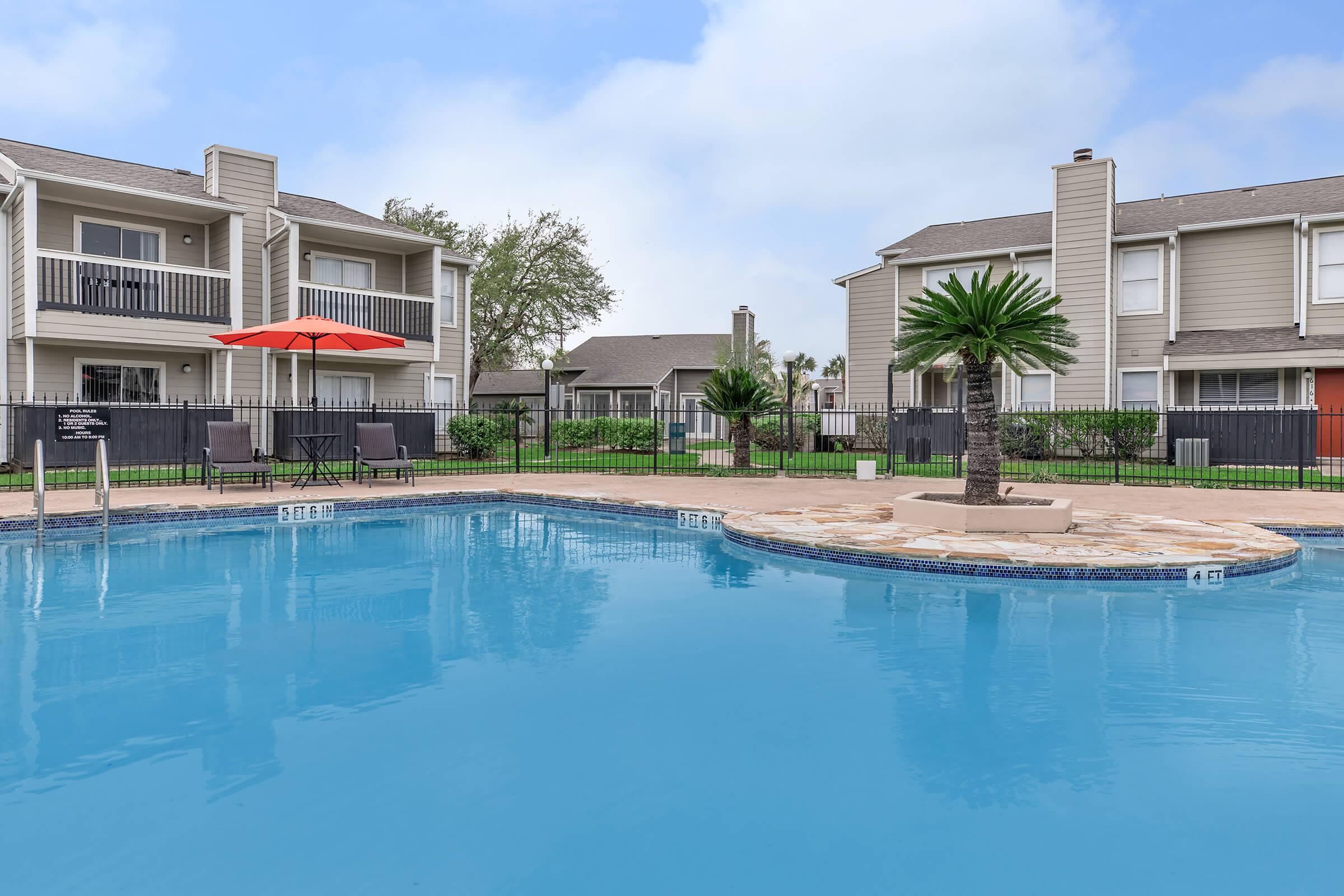 a large pool of water in front of a house