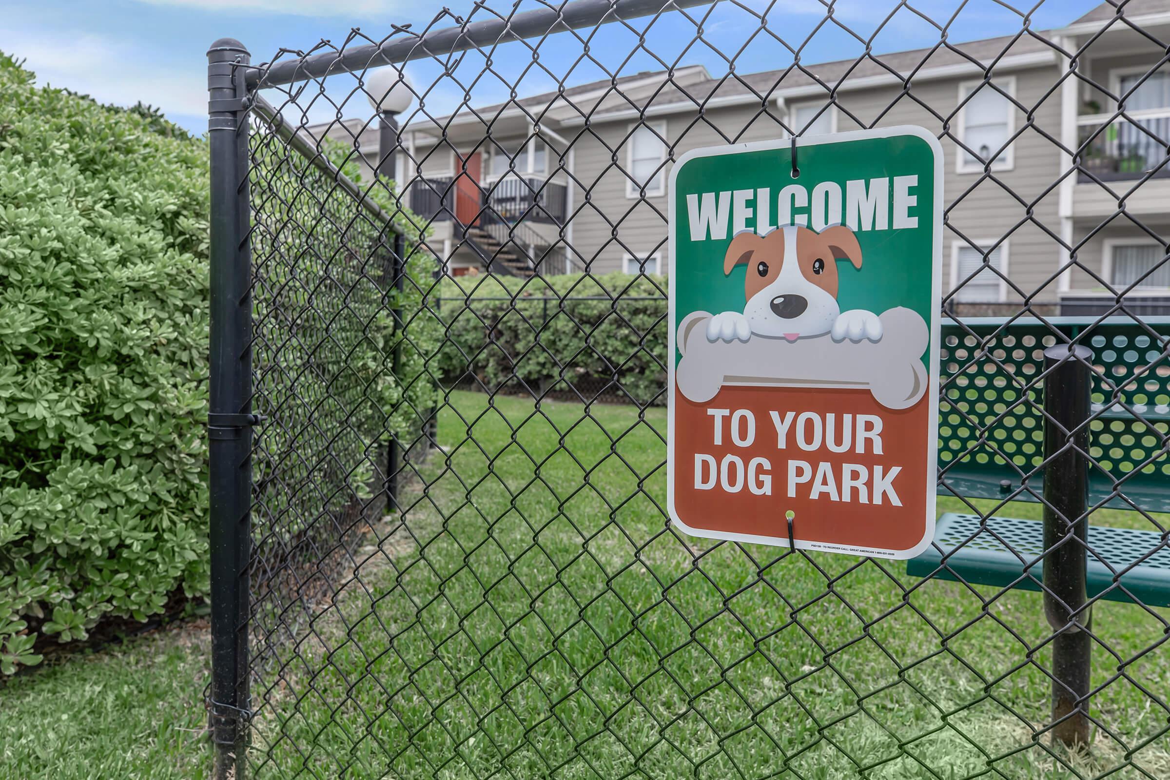 a sign in front of a fence