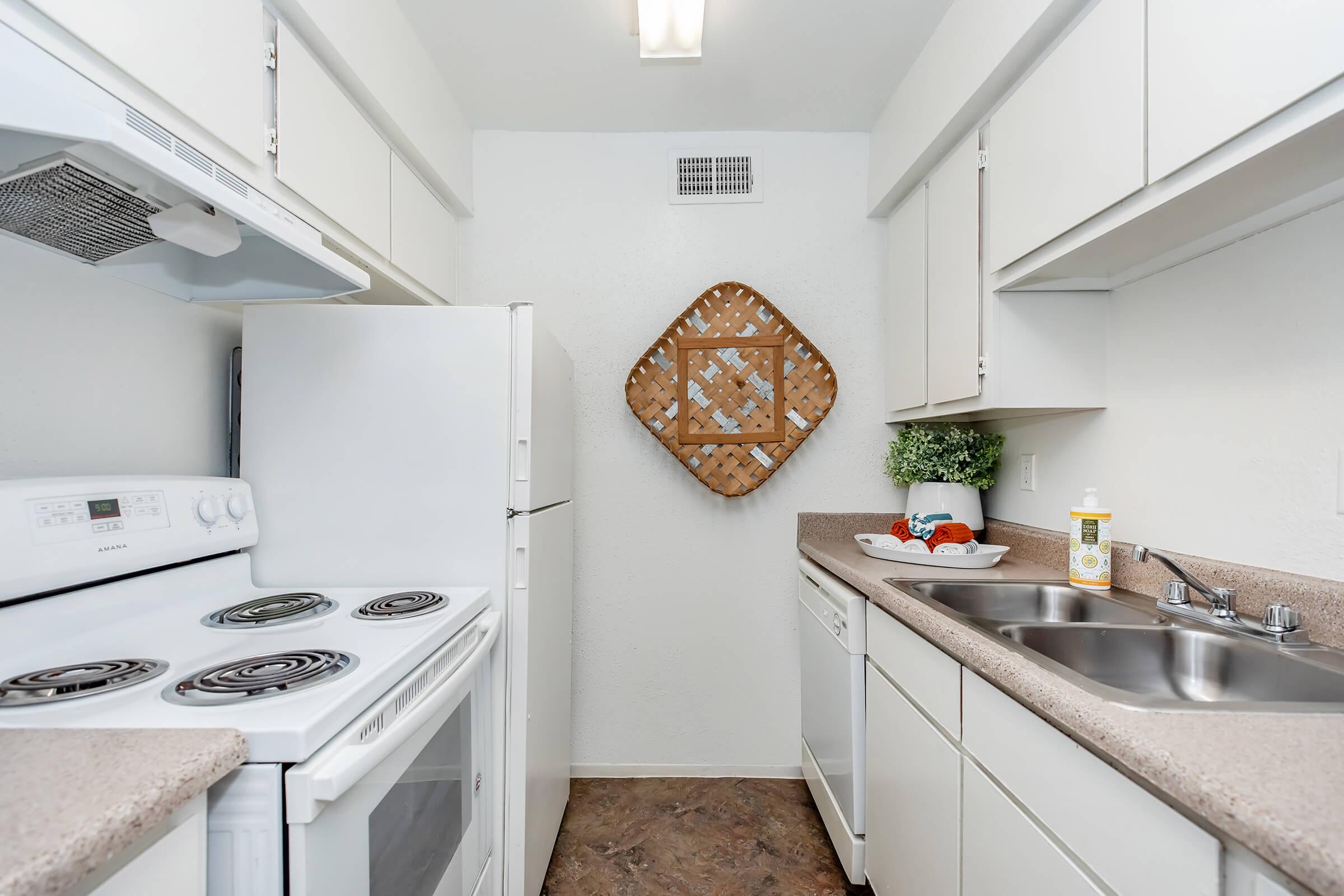 a kitchen with a stove top oven sitting next to a sink