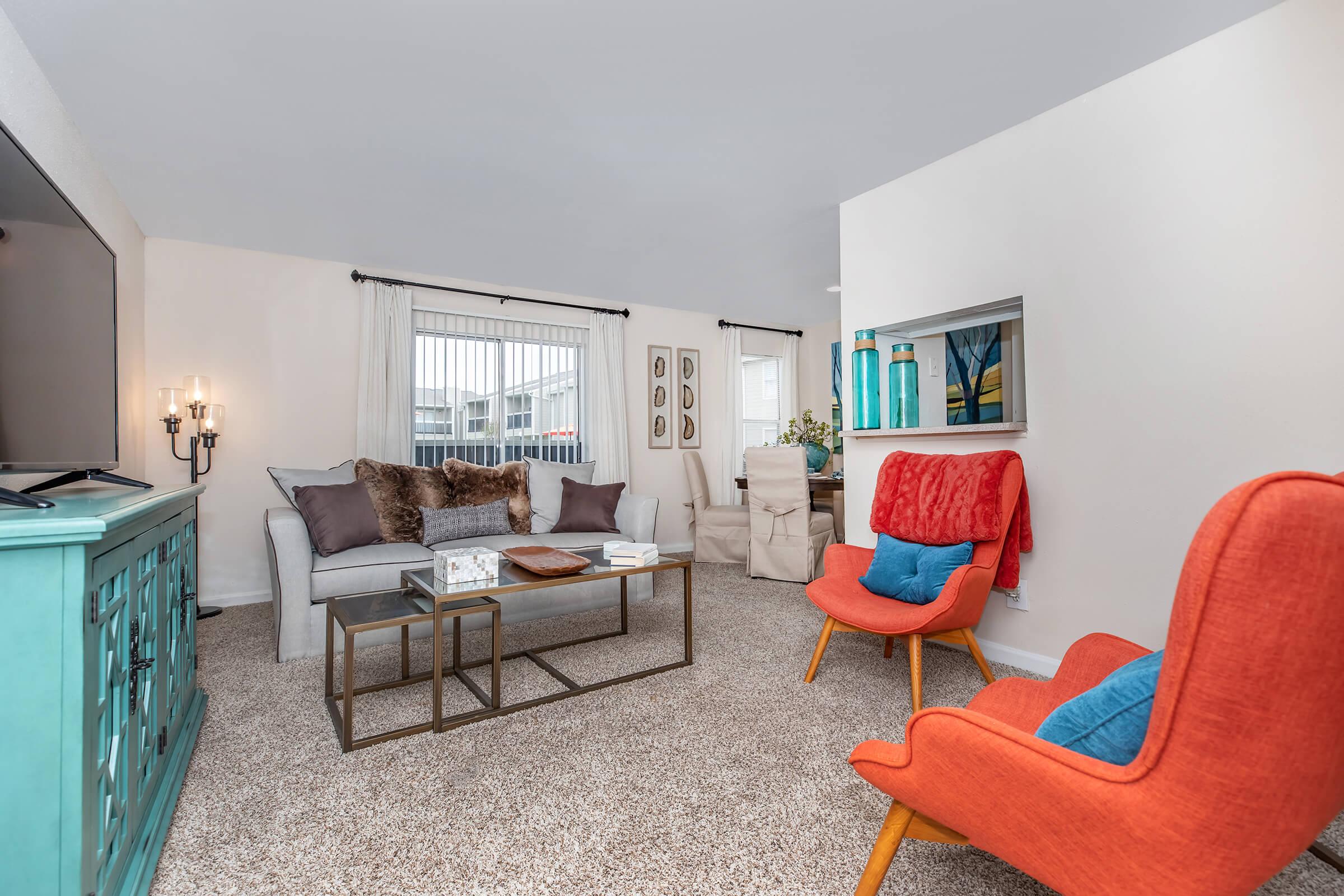 a living room filled with furniture and a window