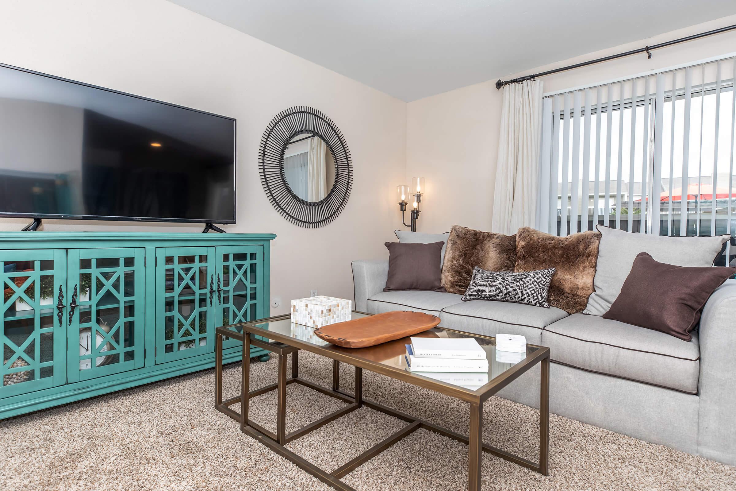 a living room filled with furniture and a large window