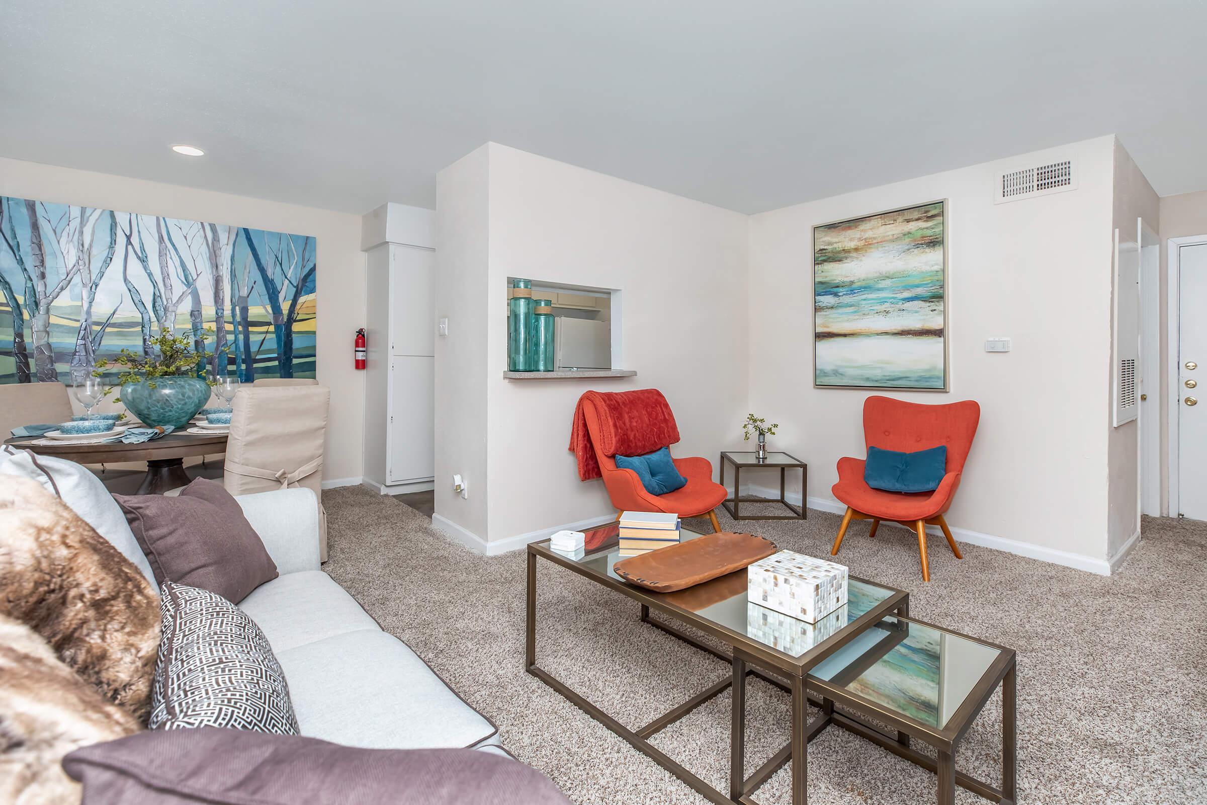 a living room filled with furniture and a large window