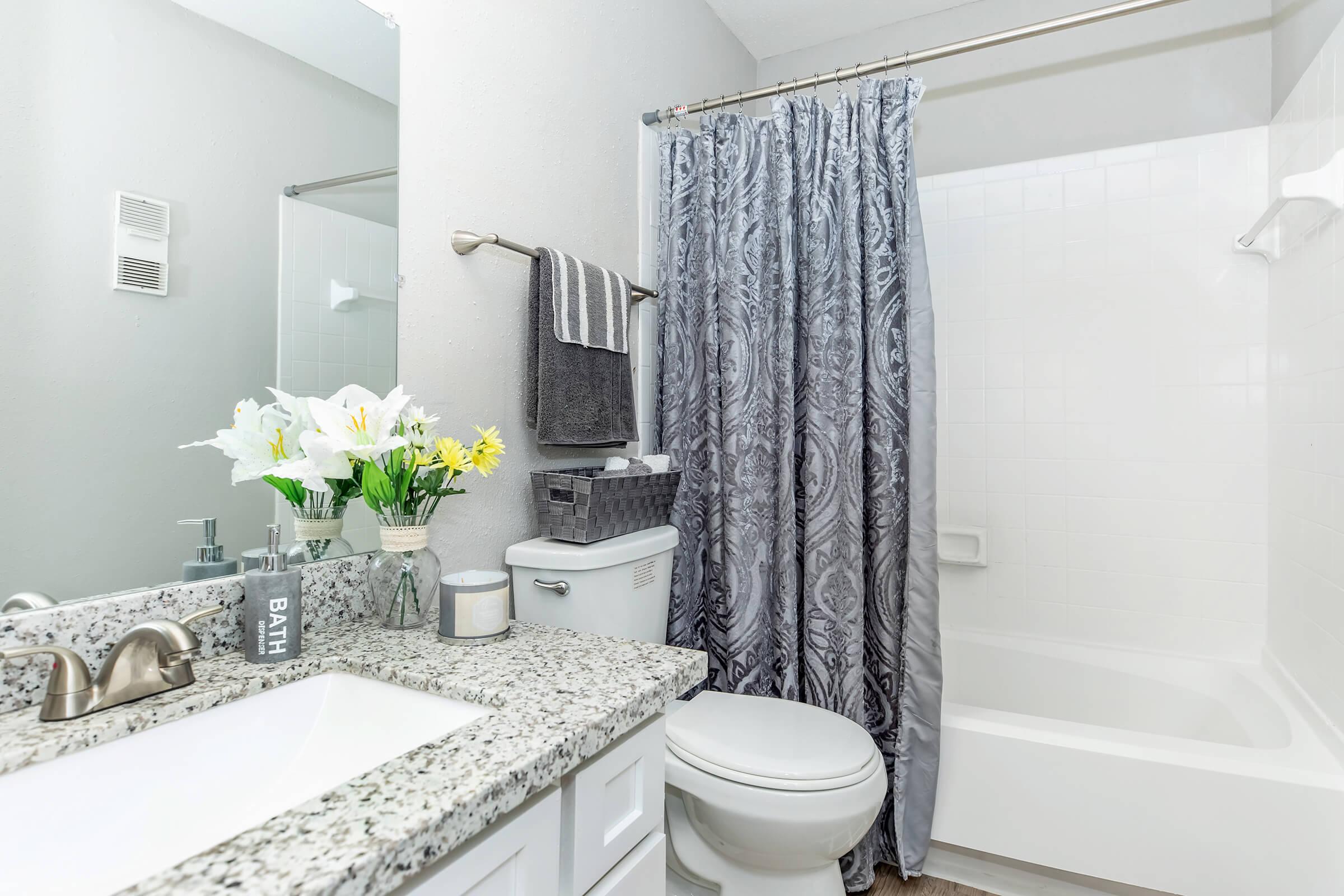 a shower curtain next to a sink