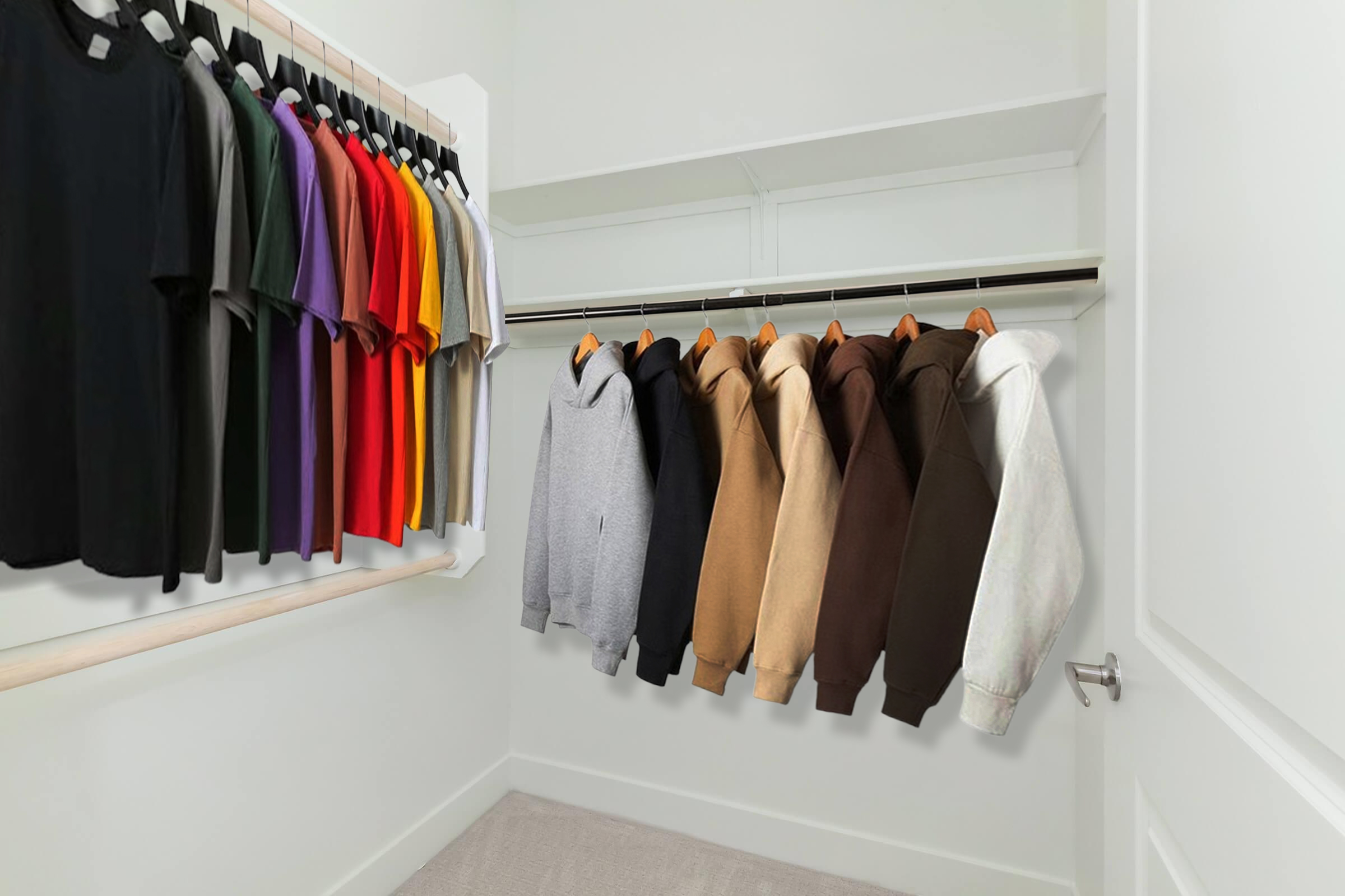 A neatly organized closet featuring a variety of hoodies and t-shirts. The hoodies are in shades of gray, brown, and cream, while the t-shirts hang in vibrant colors like purple, red, and yellow, all displayed on a clothing rack against a plain white wall.
