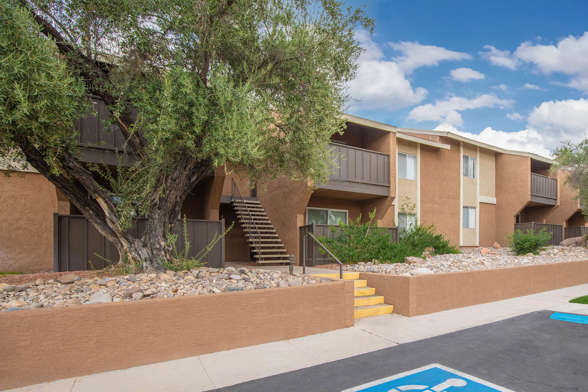 a dirt road in front of a building