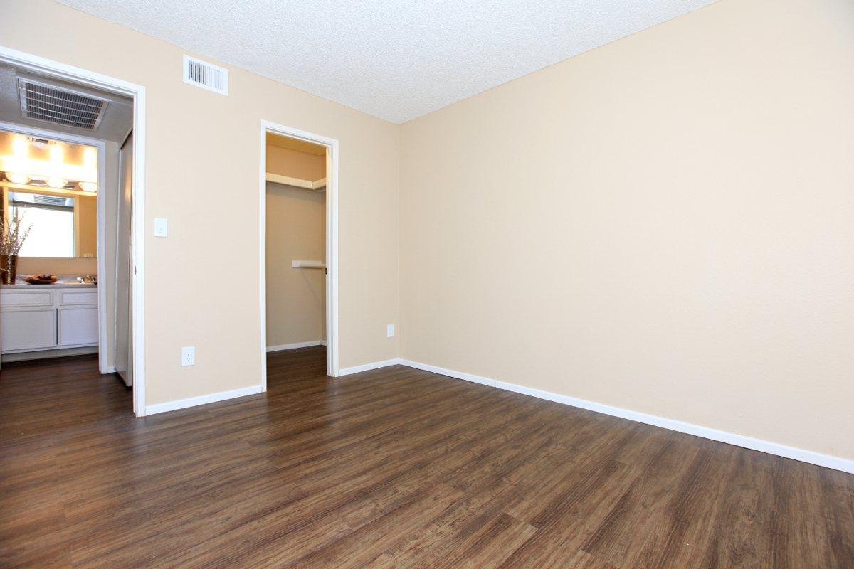 a large empty room with a wood floor