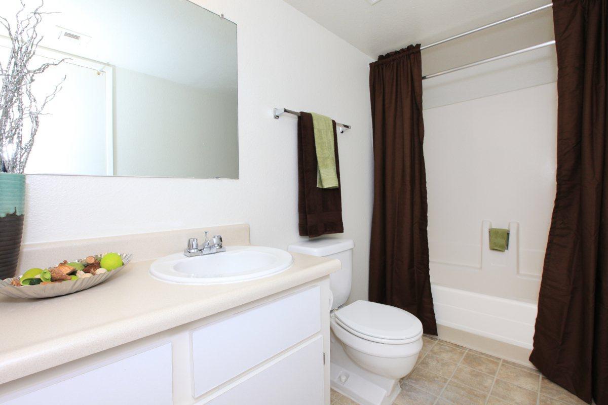 a white sink sitting next to a window