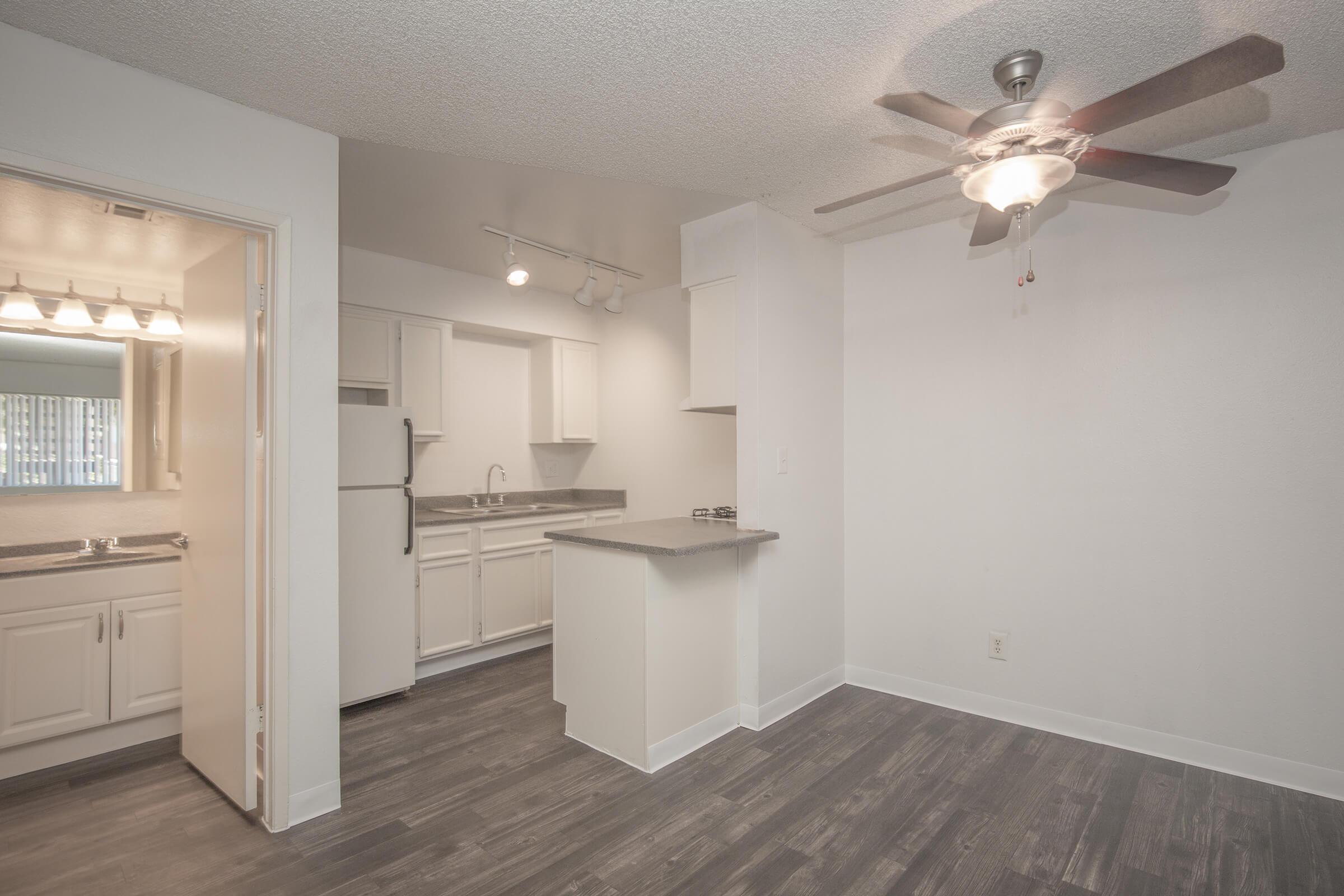 a kitchen with white cabinets